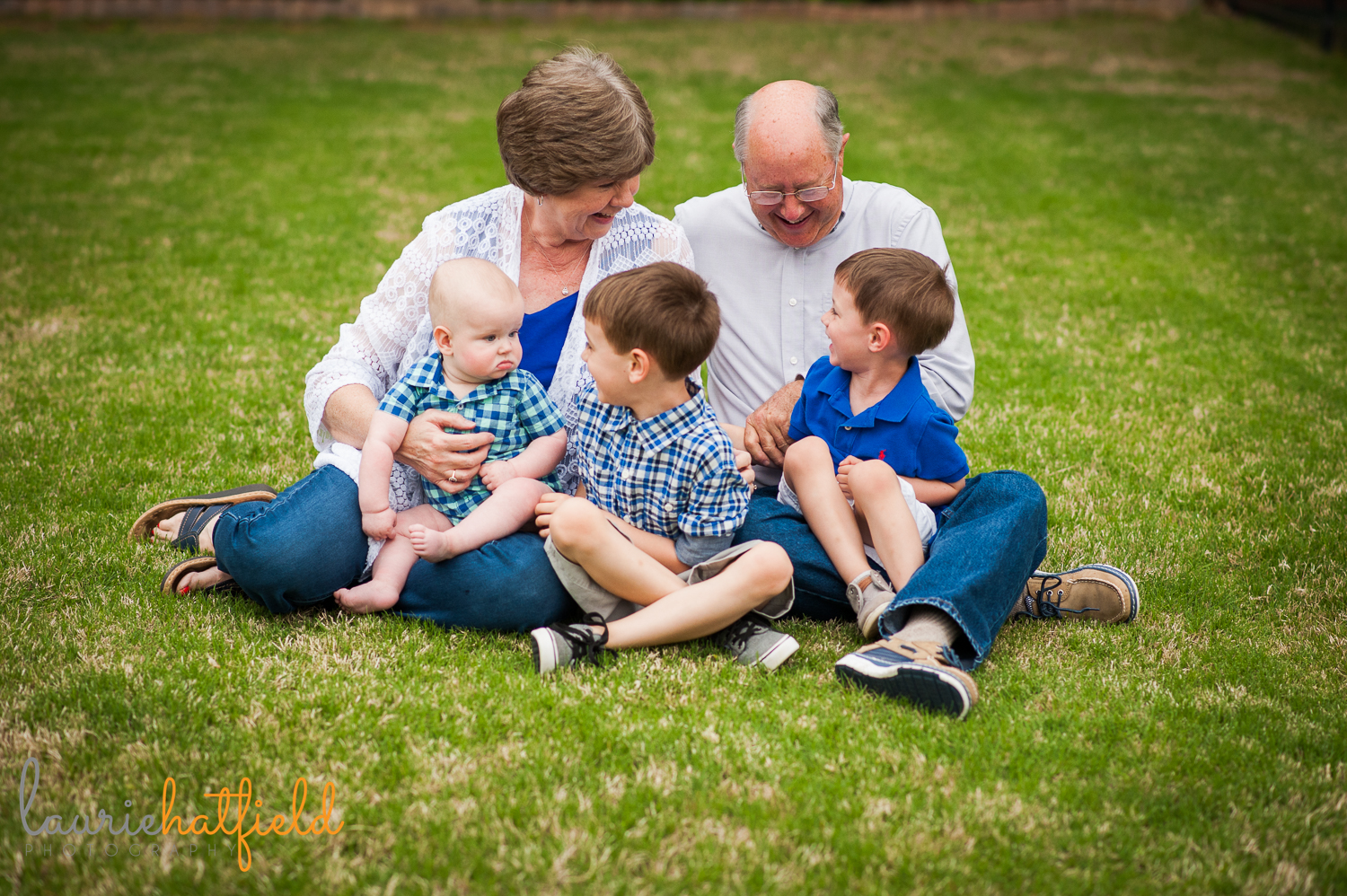 grandparents sitting on grass with three grandsons | Huntsville family photographer