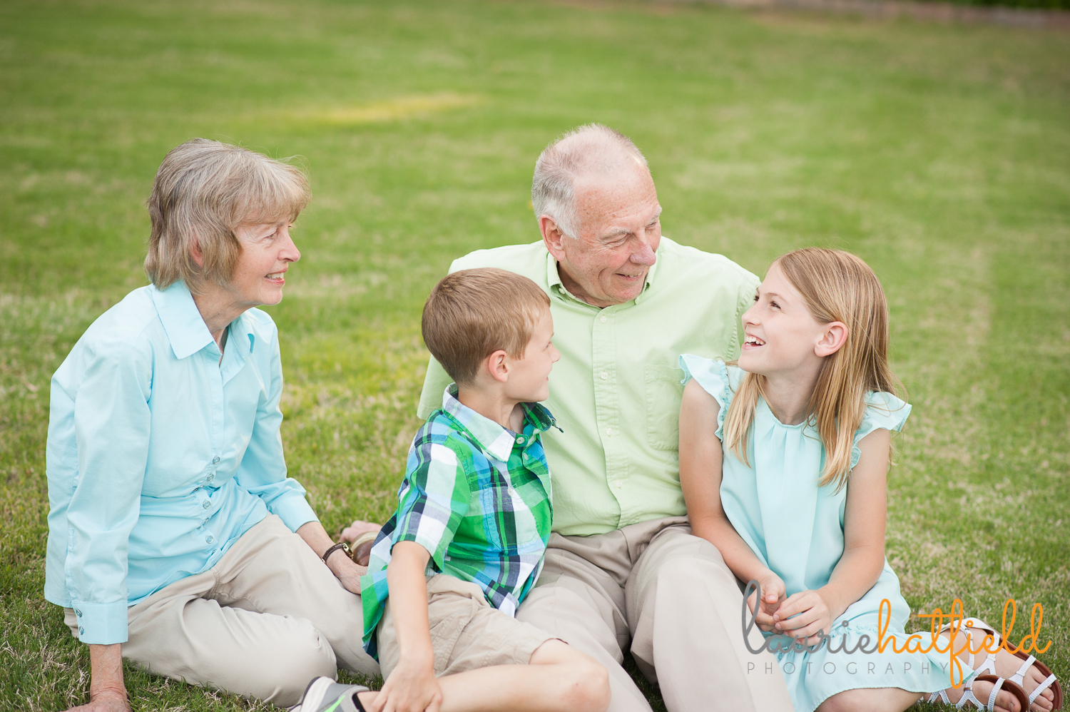 grandparents sitting on grass with grandchildren | Huntsville family photographer