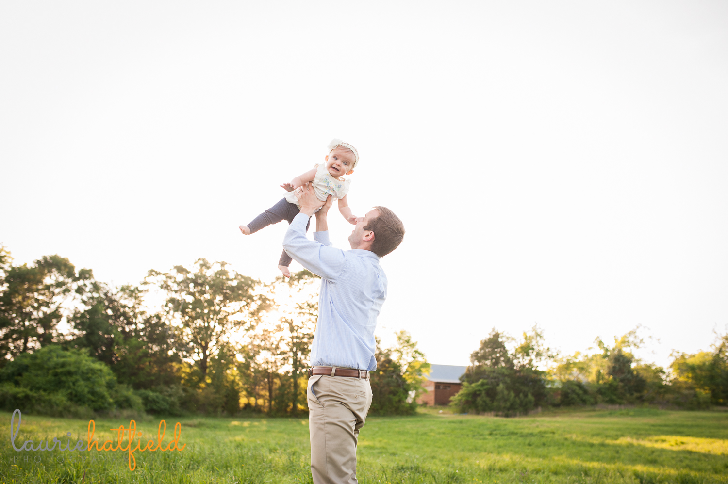 dad tossing baby girl in air | Huntsville family photographer