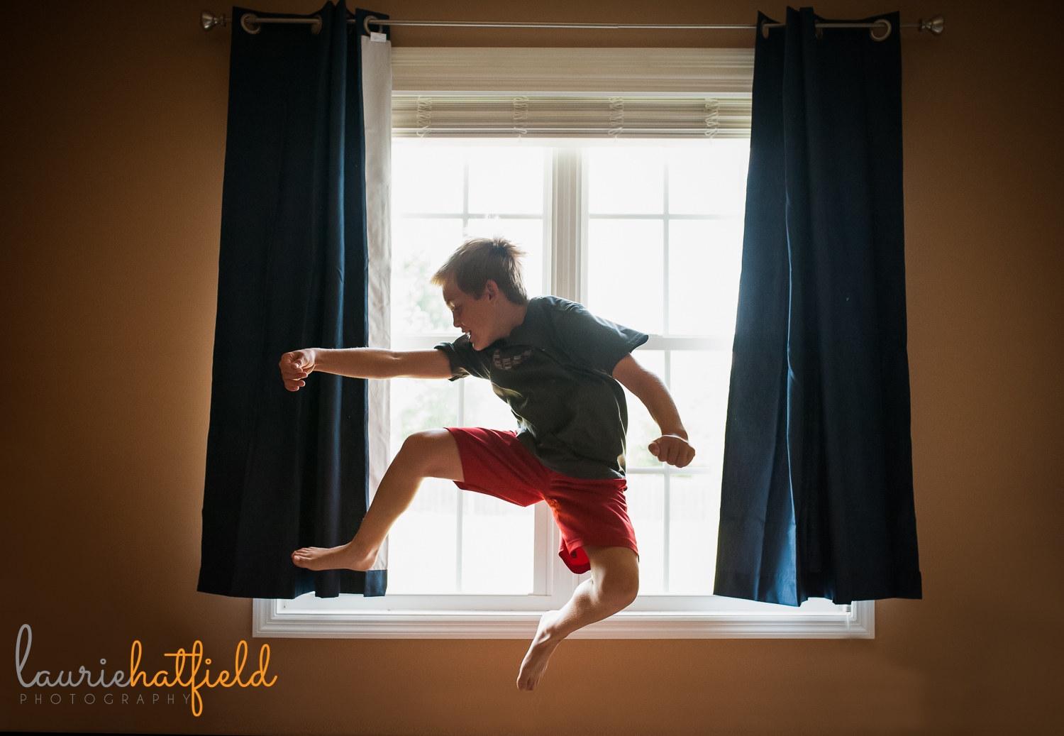 boy jumping in front of window | Huntsville child photographer 
