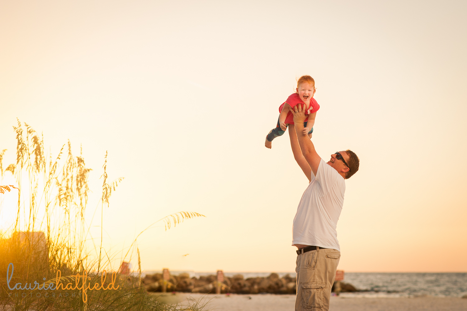 dad holding daughter on beach | Huntsville family photographer