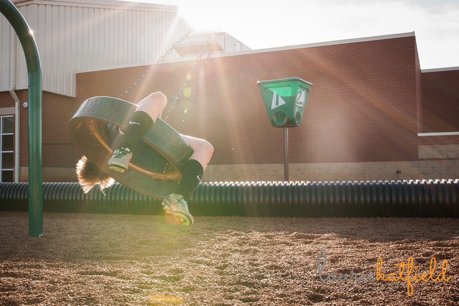 boy on tire swing in sunlight | Huntsville photographer