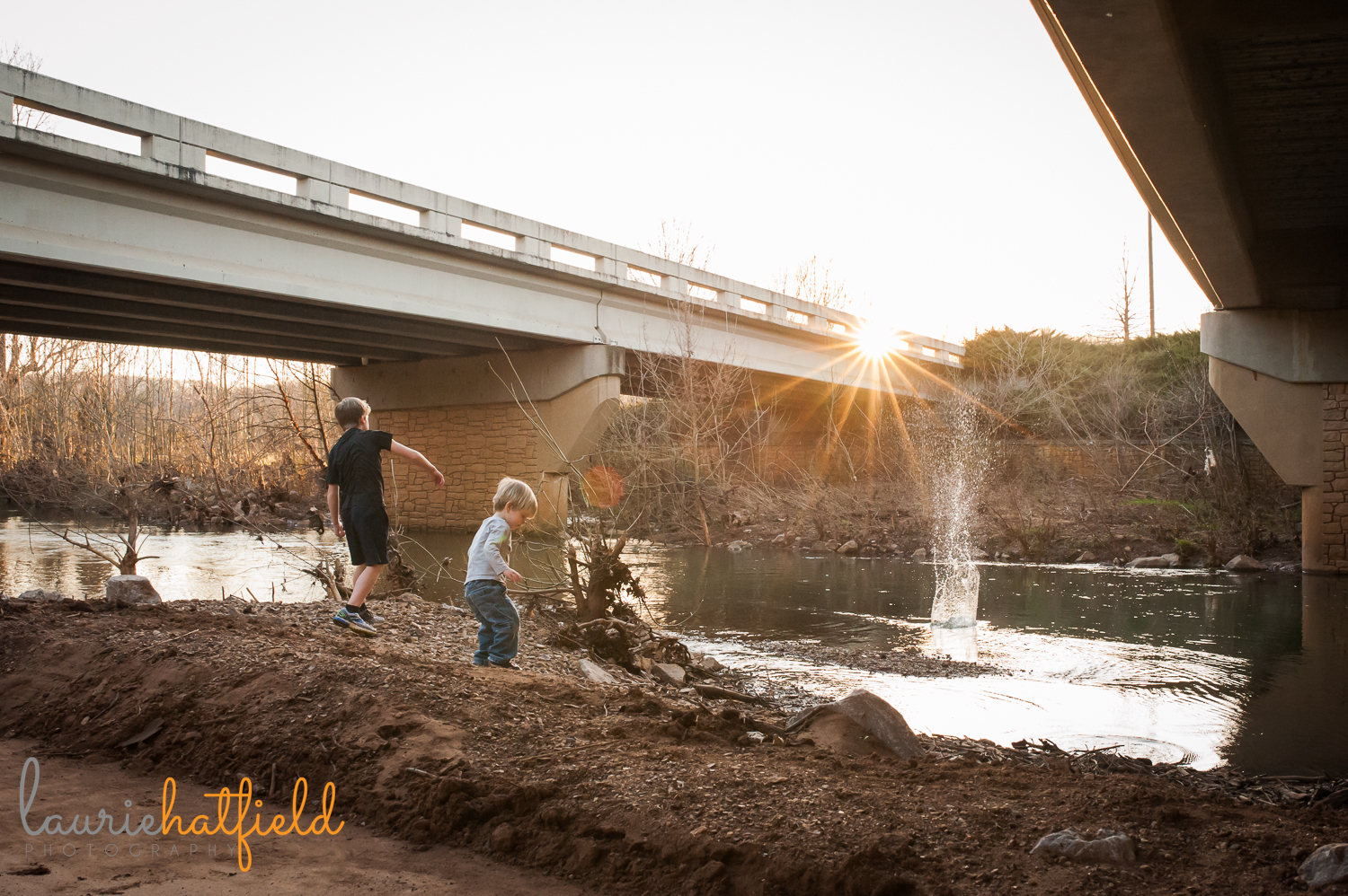 two boys throwing rocks into creek | Huntsville family photographer