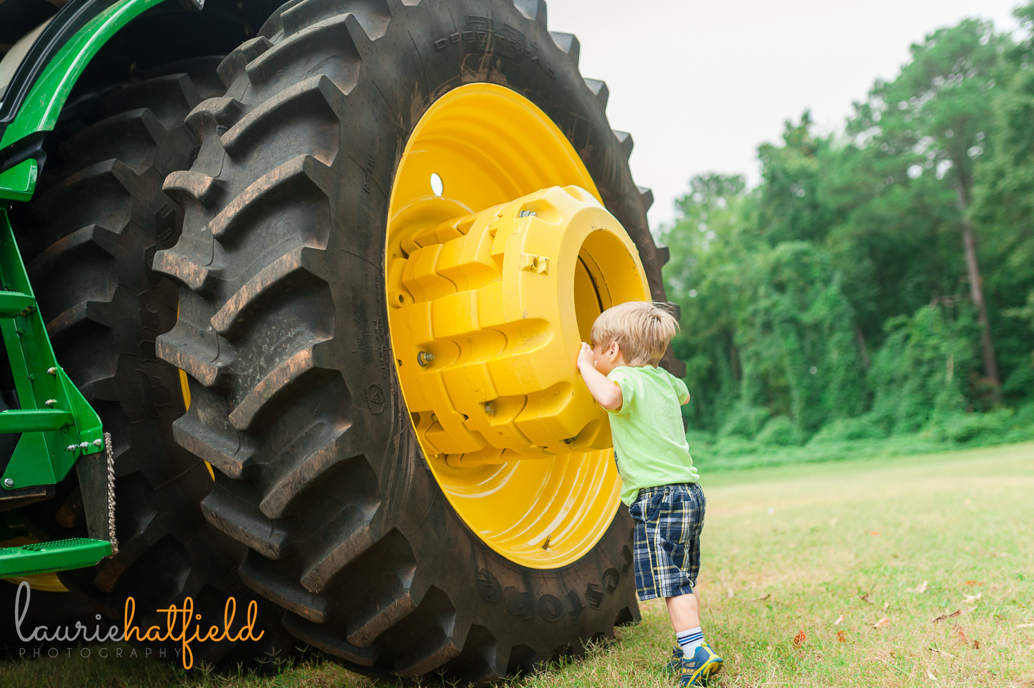 little boy peering into tractor tire | Huntsville photographer