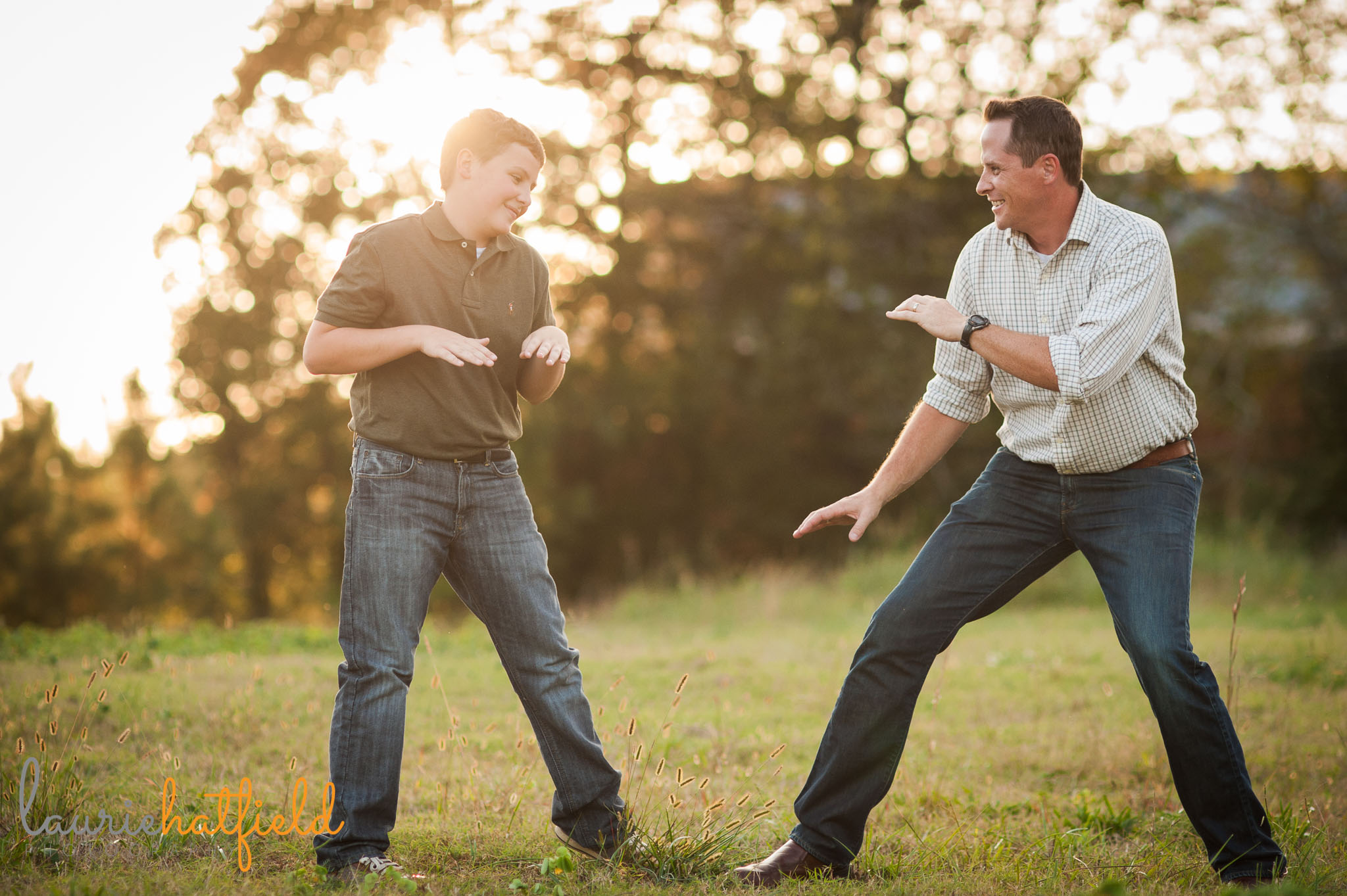 dad and son playing karate in a field | Mobile family photographer
