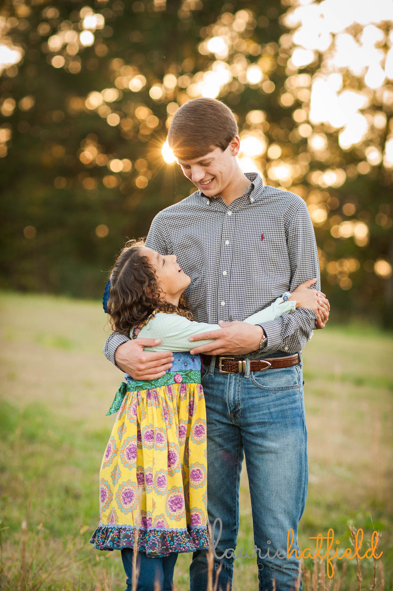 little sister looking up at big brother | Mobile AL family photographer | Laurie Hatfield Photography