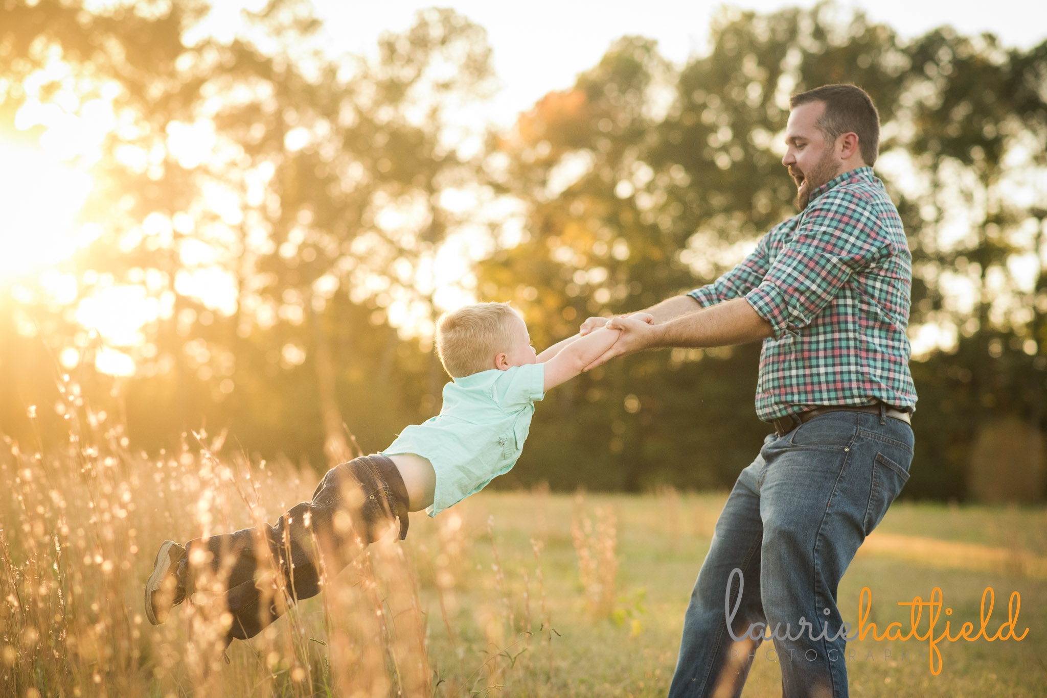 dad swinging little boy around in a field | Mobile AL family photographer