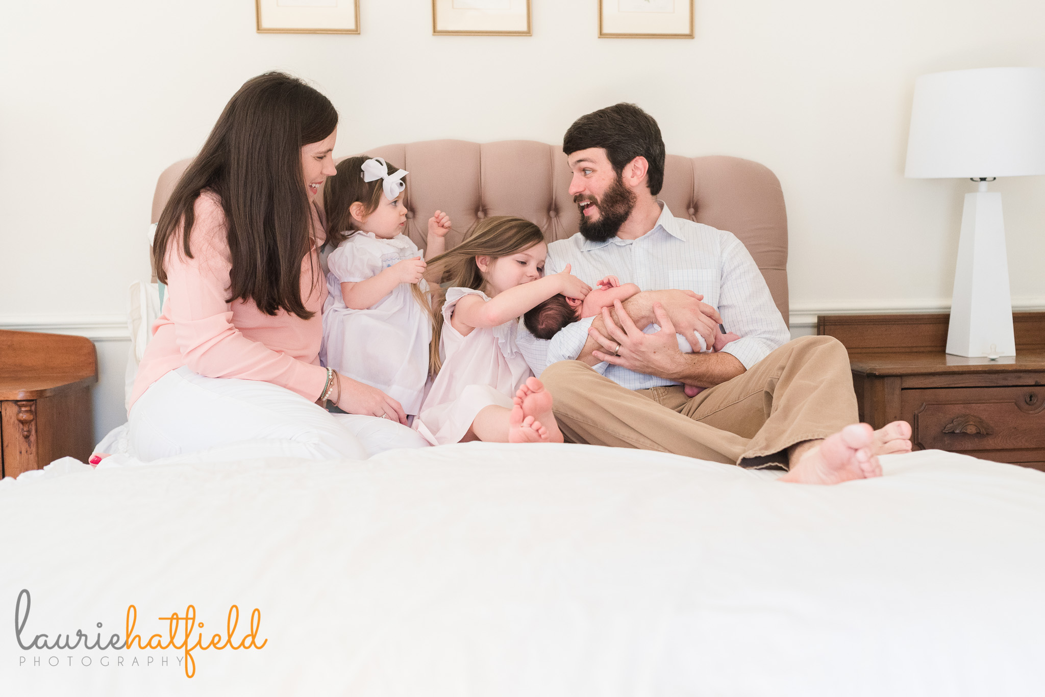 family of five on bed with new baby | Mobile AL newborn photographer