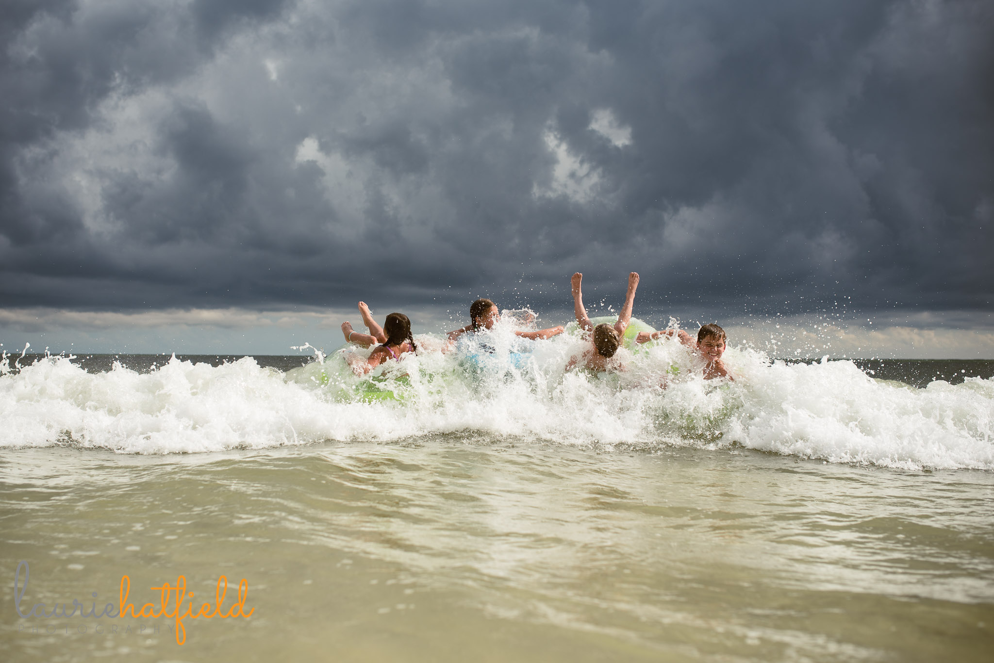 4 kids playing on floats at the beach | Mobile AL family photographer