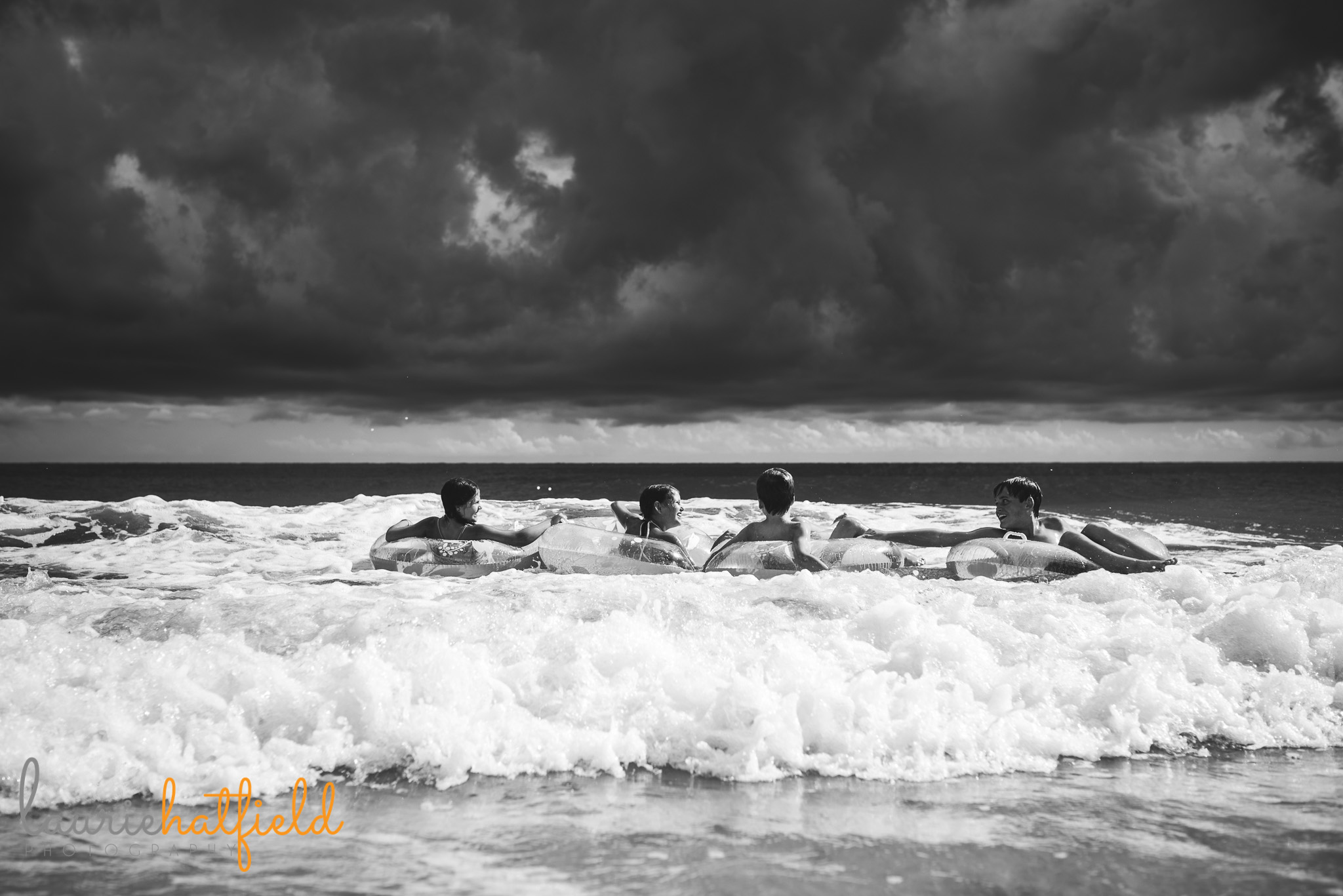 4 children playing in ocean | Mobile AL family photographer