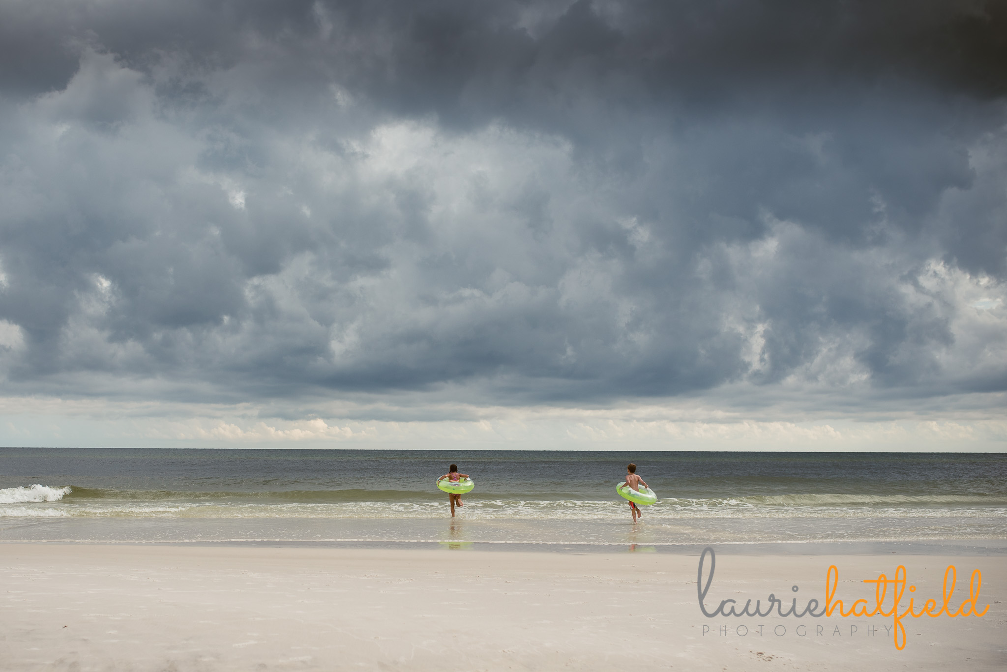 2 kids running towards ocean | Mobile AL family photographer