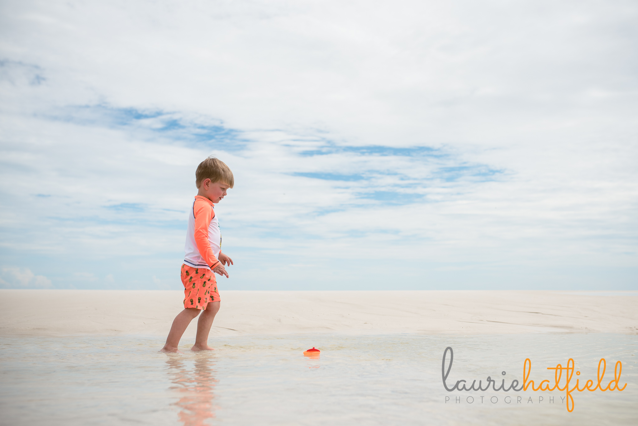 little boy walking in water on the beach | Mobile AL family photographer
