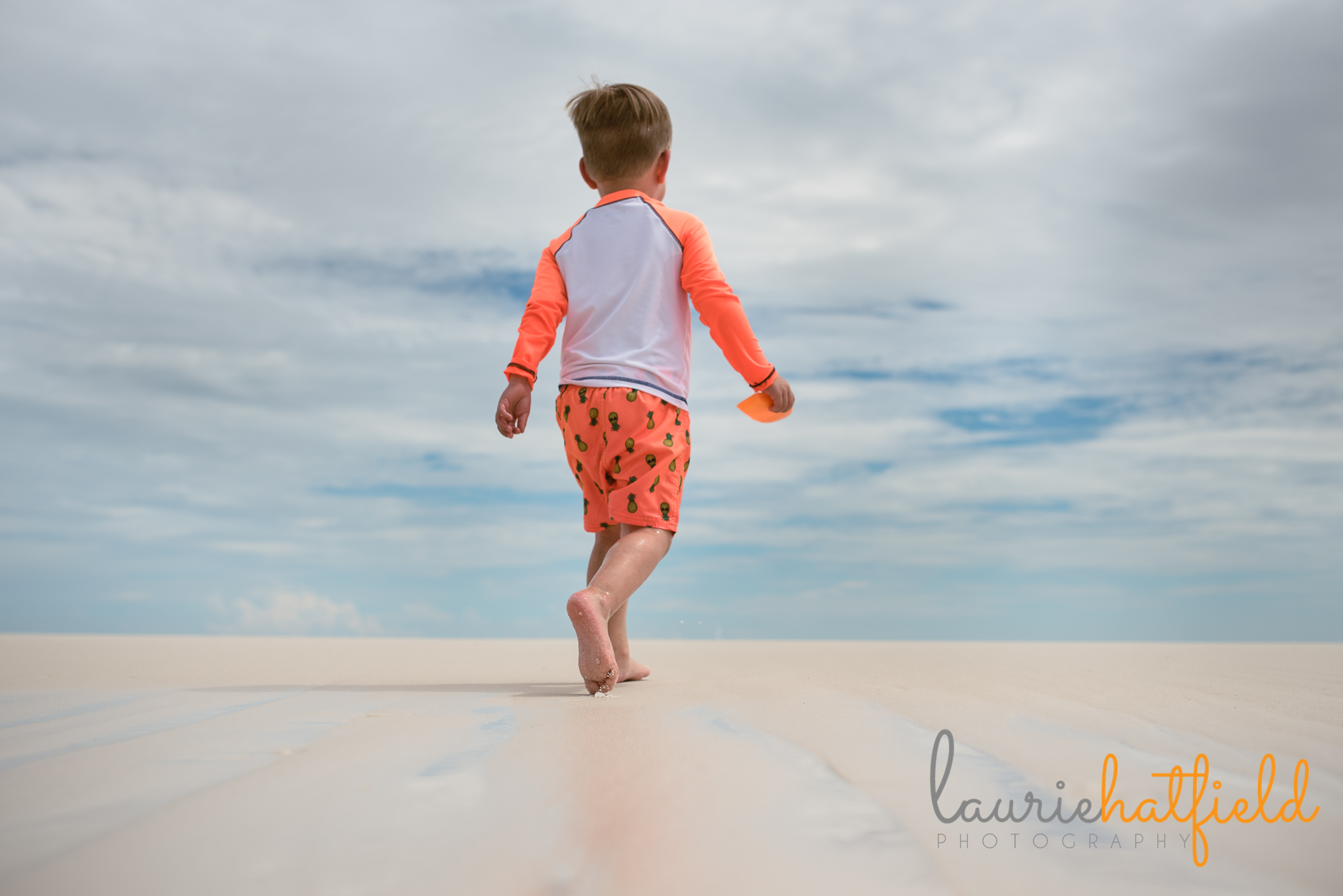 little boy walking on the beach | Mobile AL family photographer