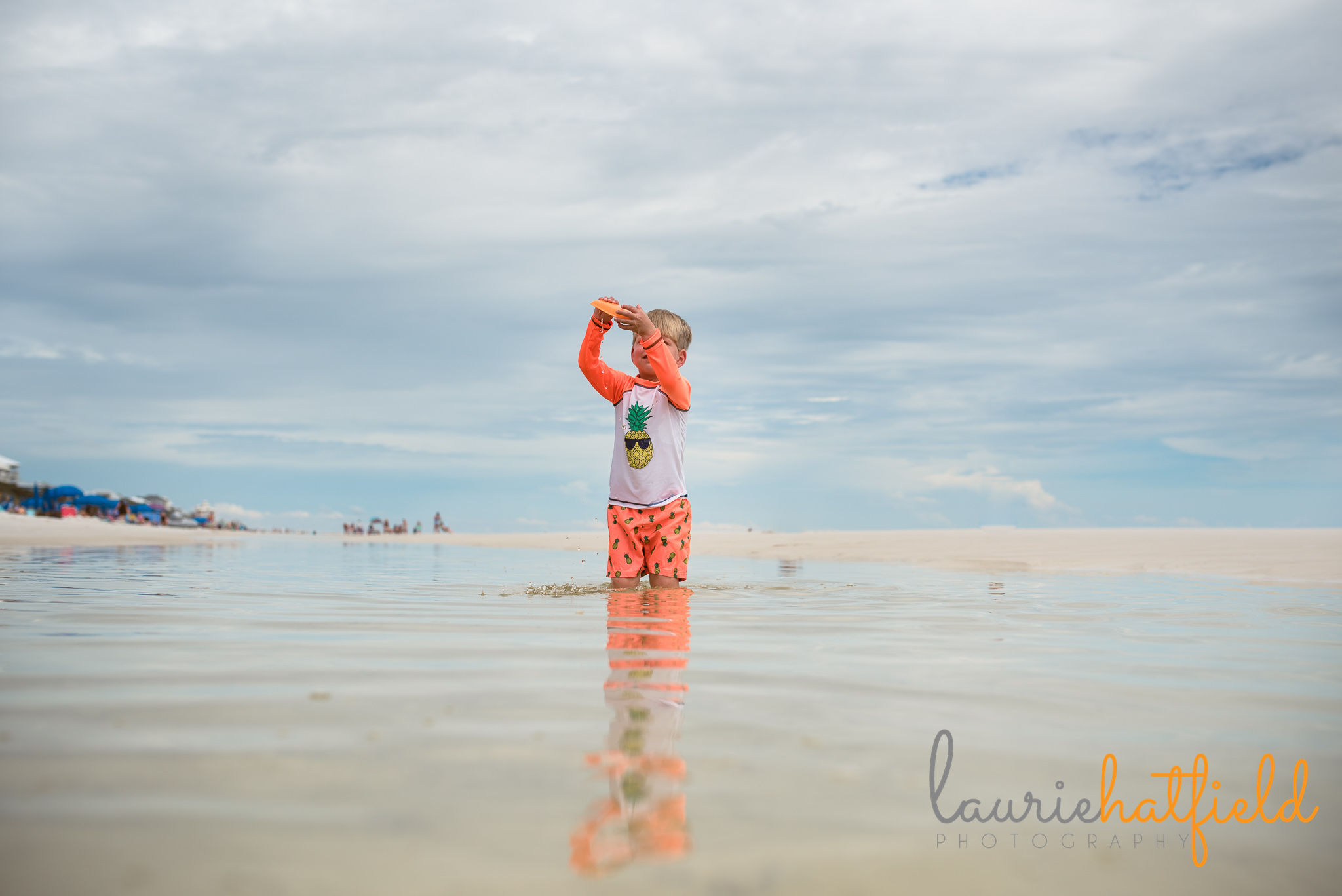 little boy playing with a boat on the beach | Mobile AL family photographer