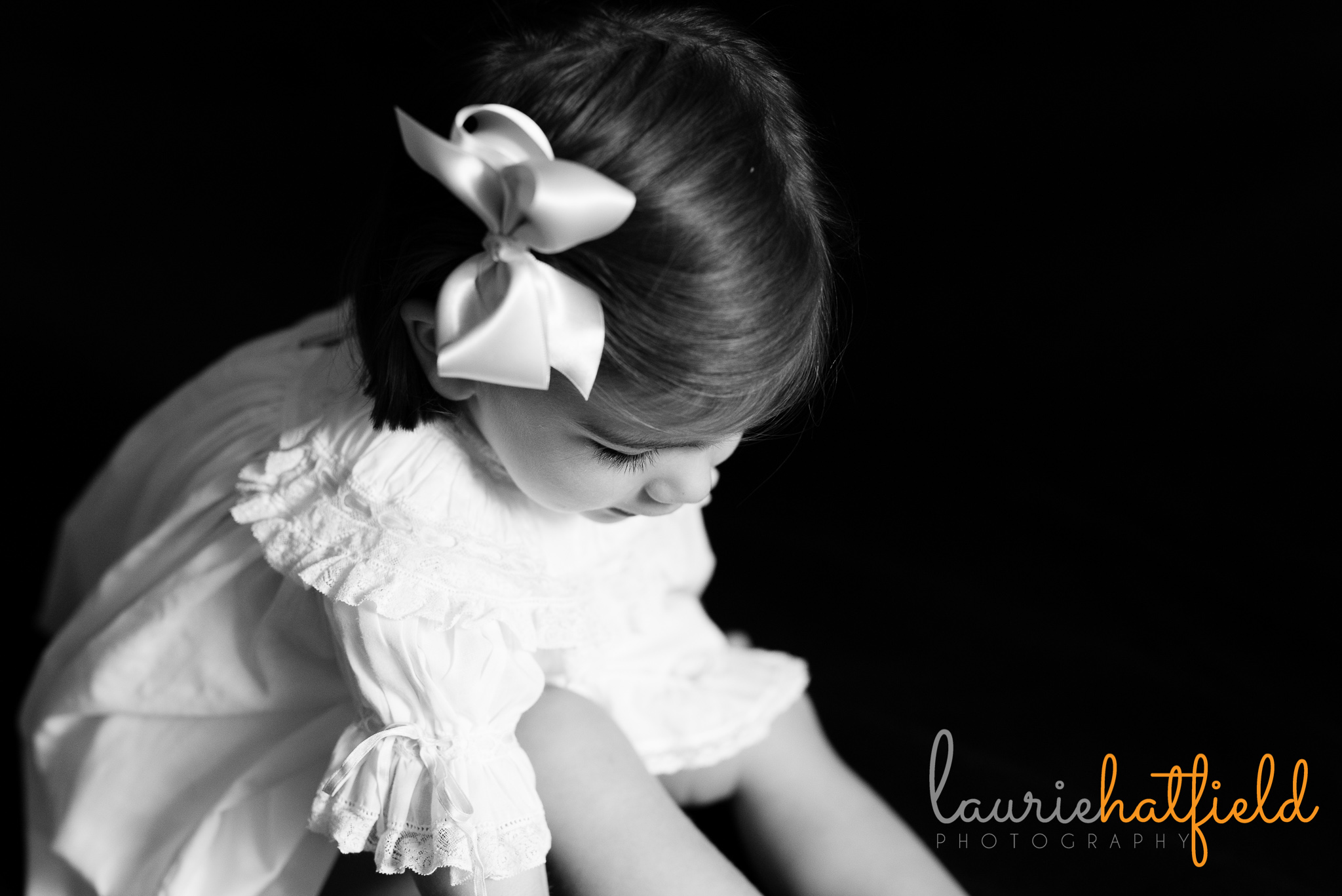 2 year old girl in dress looking down | Mobile al preschool portraits