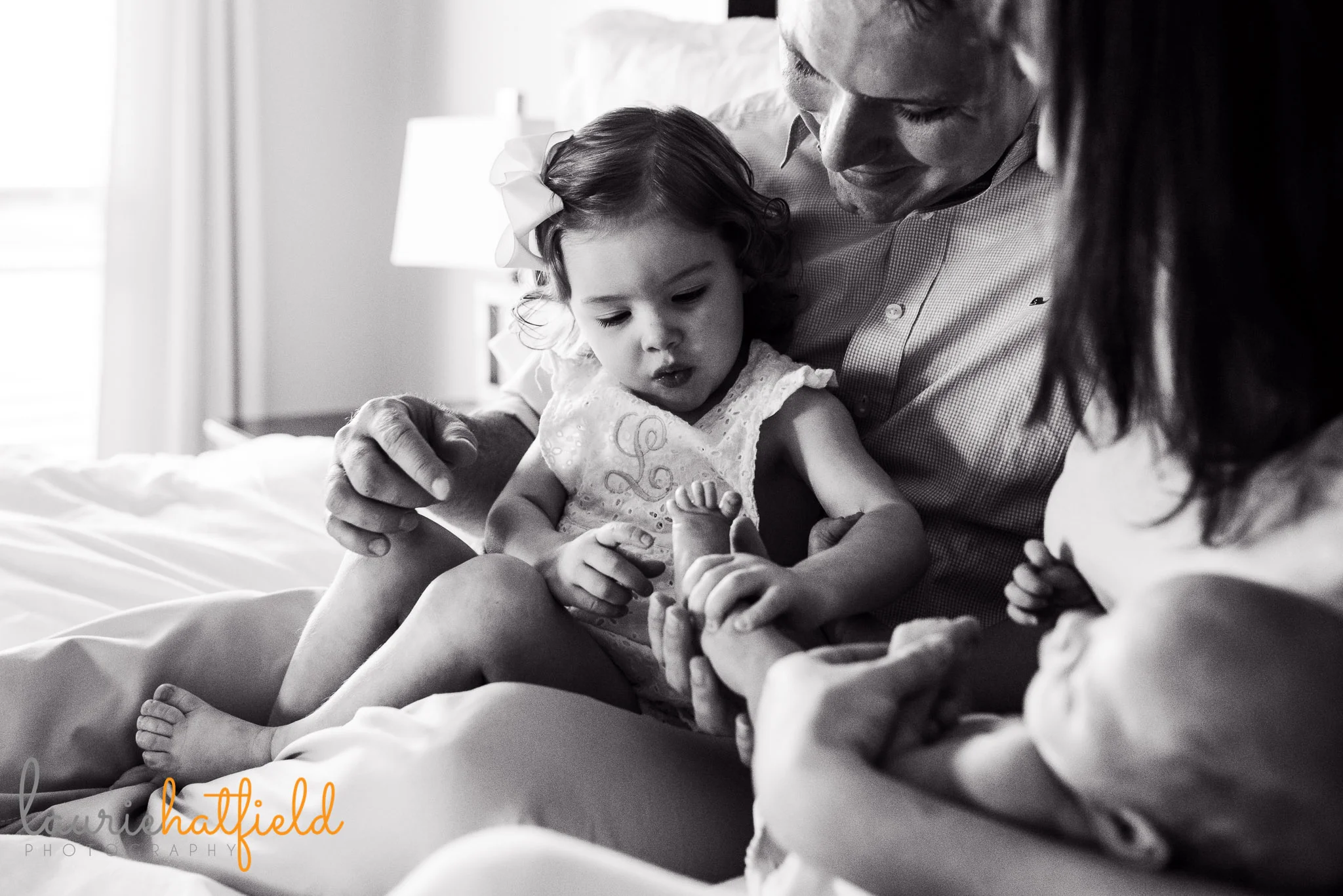 family of four on bed | Mobile Al newborn photographer