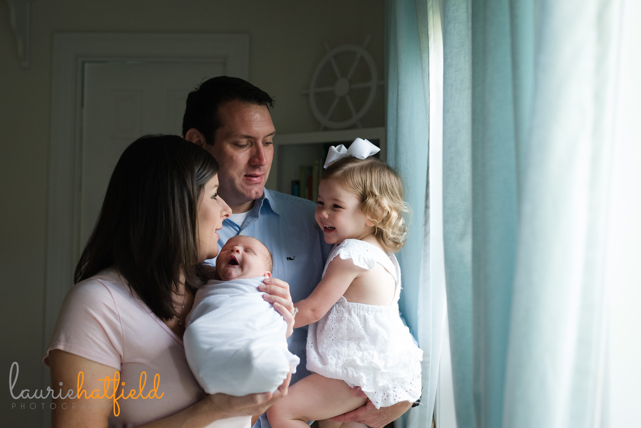family of four by window | Mobile AL newborn photographer