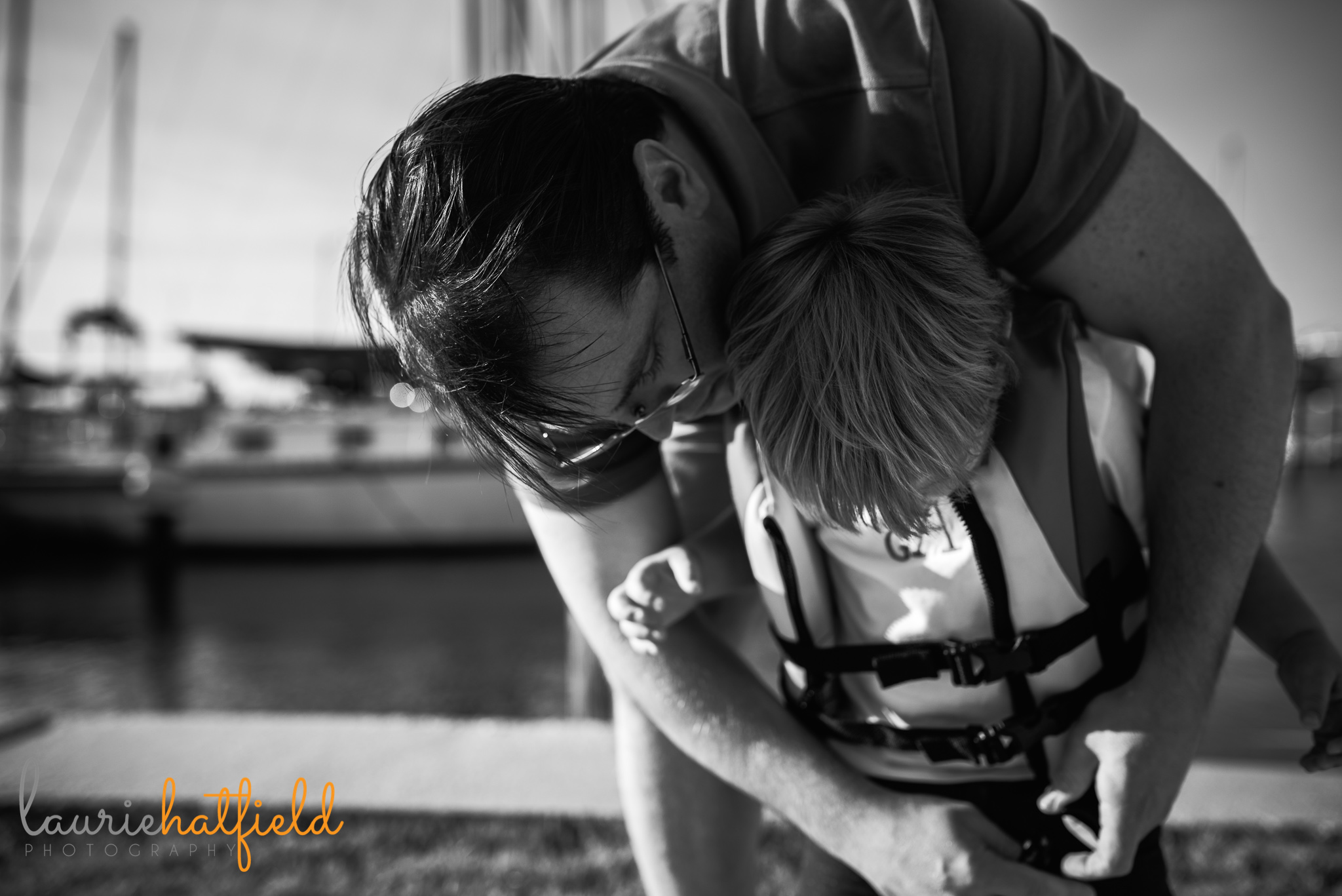 dad helping son put on life jacket | Mobile AL family photographer