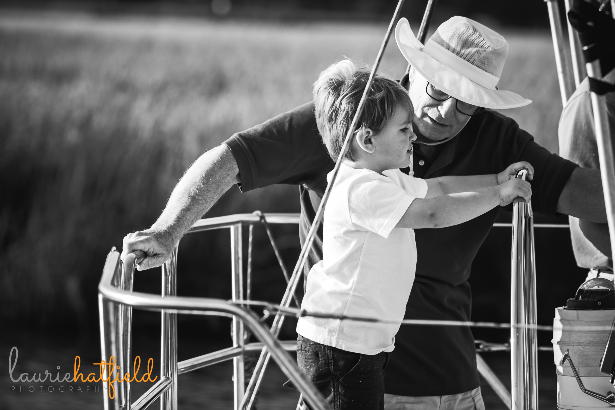 grandfather and grandson on sailboat | Mobile AL family photographer