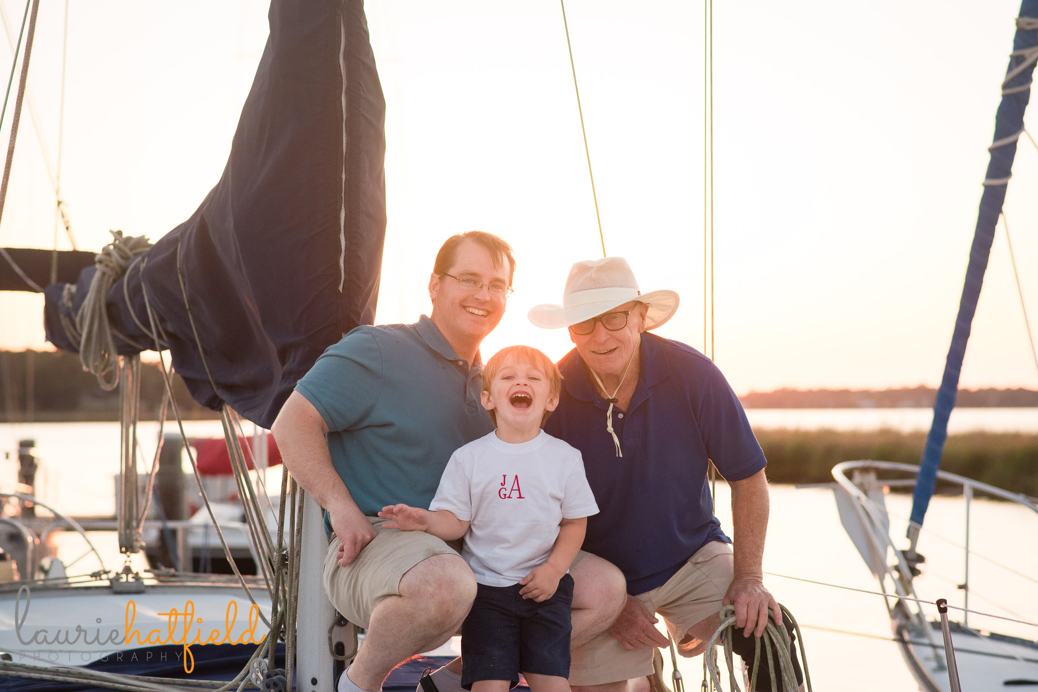 grandfather, dad, and son on sailboat | Mobile AL extended family photo session