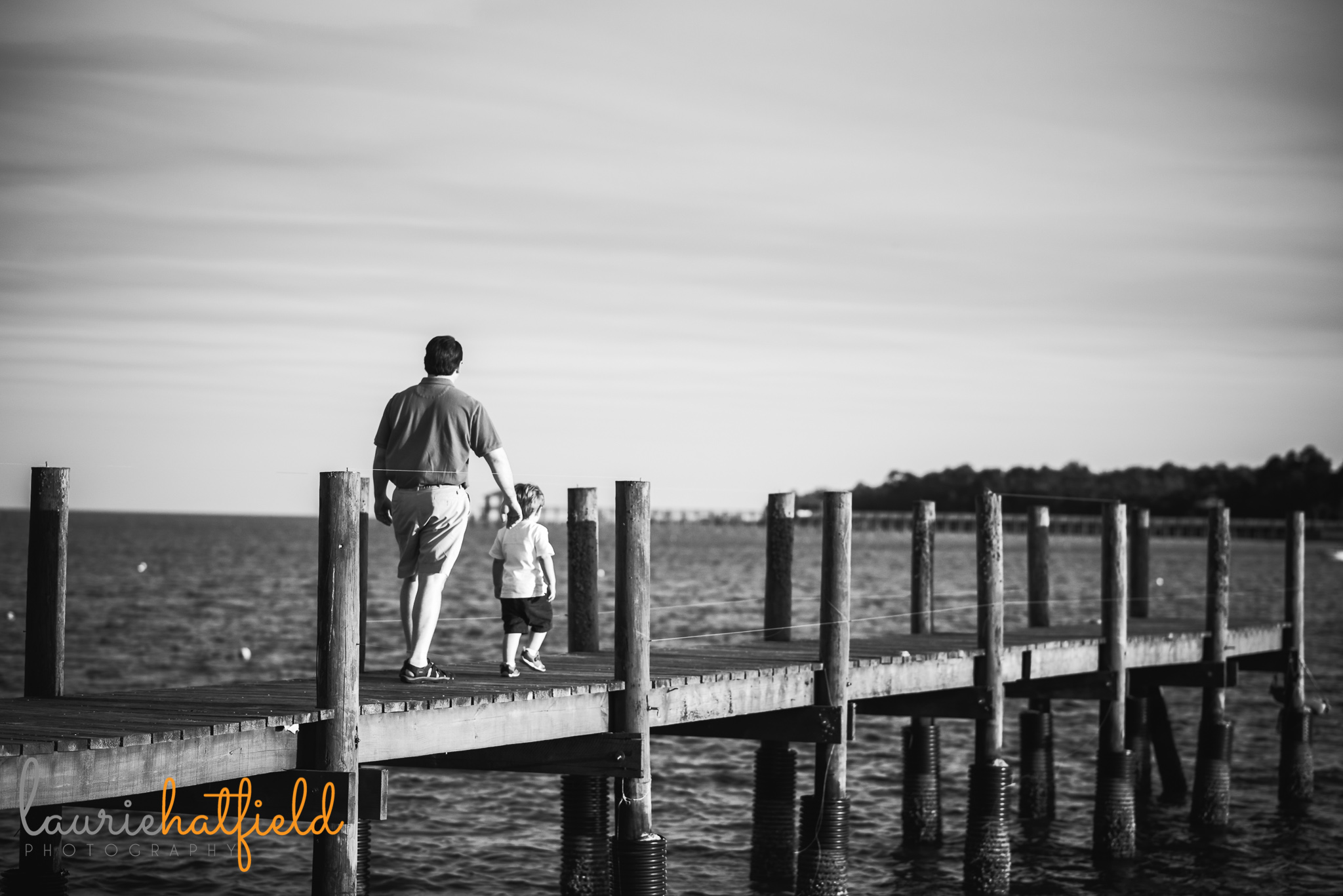 dad and son walking on pier | Mobile AL family photographer