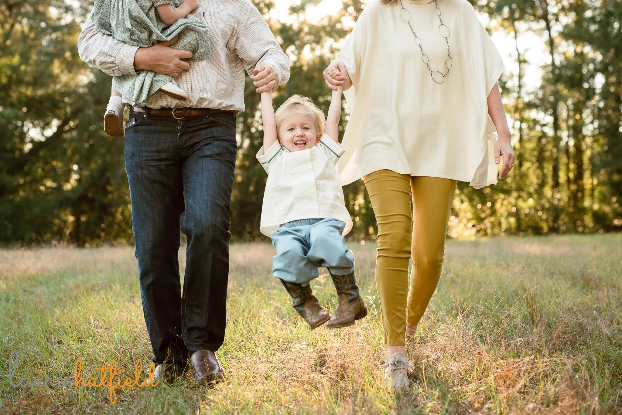 3-year-old boy swinging in parents' arms | Mobile AL family photographer