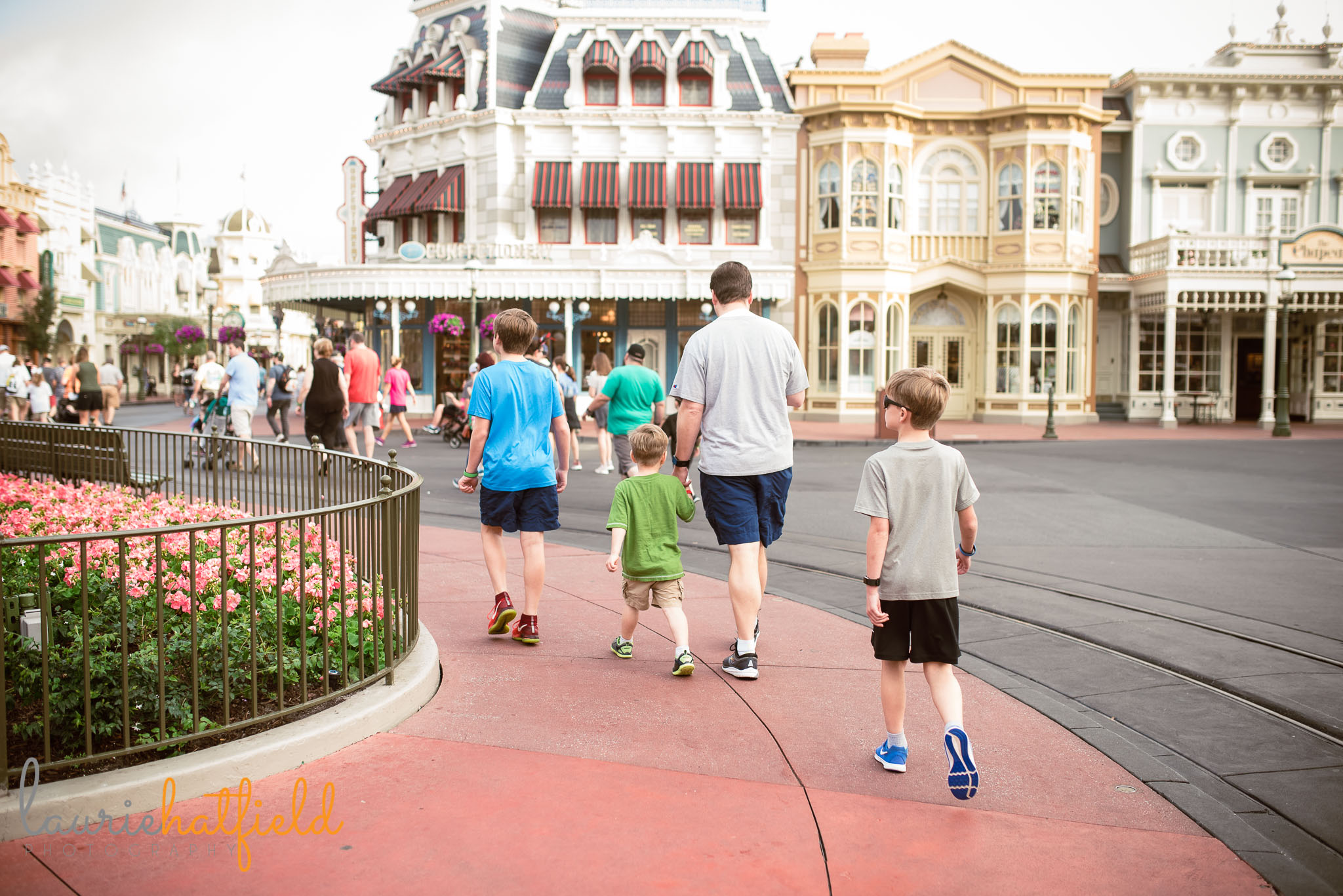 dad and boys walking in Magic Kingdom | Mobile AL family photographer