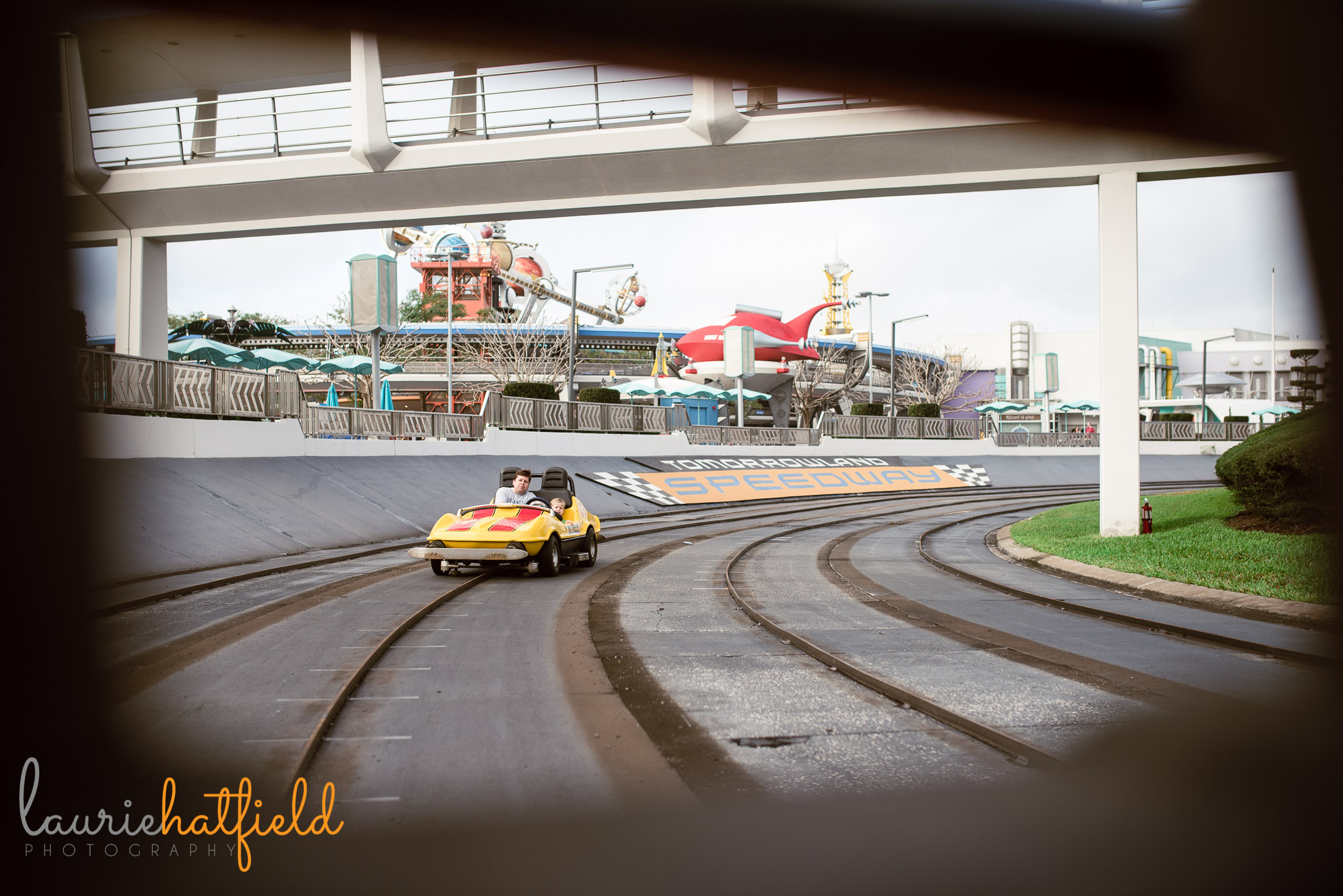 dad and son on Tomorrowland Speedway | Mobile AL family photographer