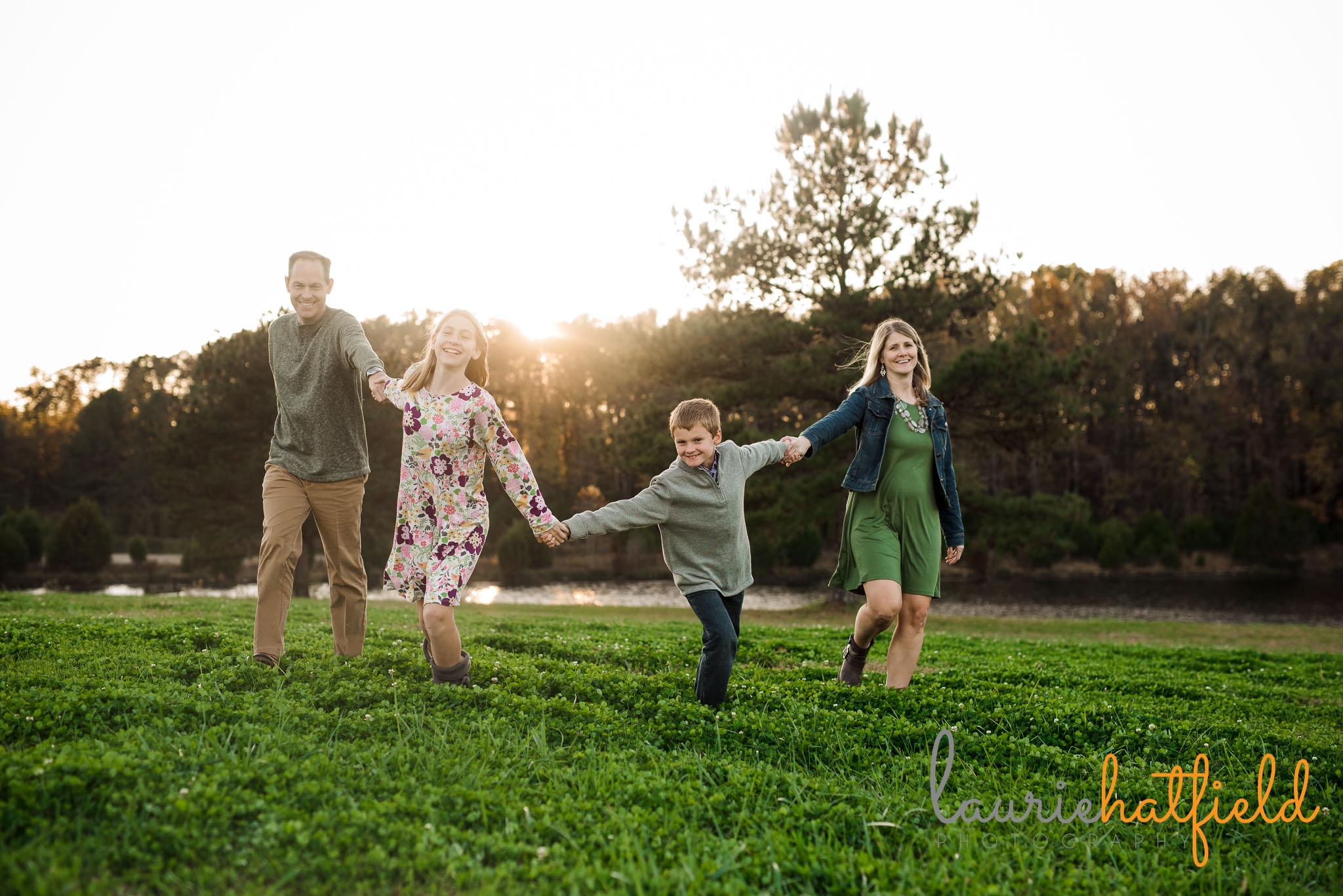 mom, dad, son, and daughter running in field | Mobile AL family photographer