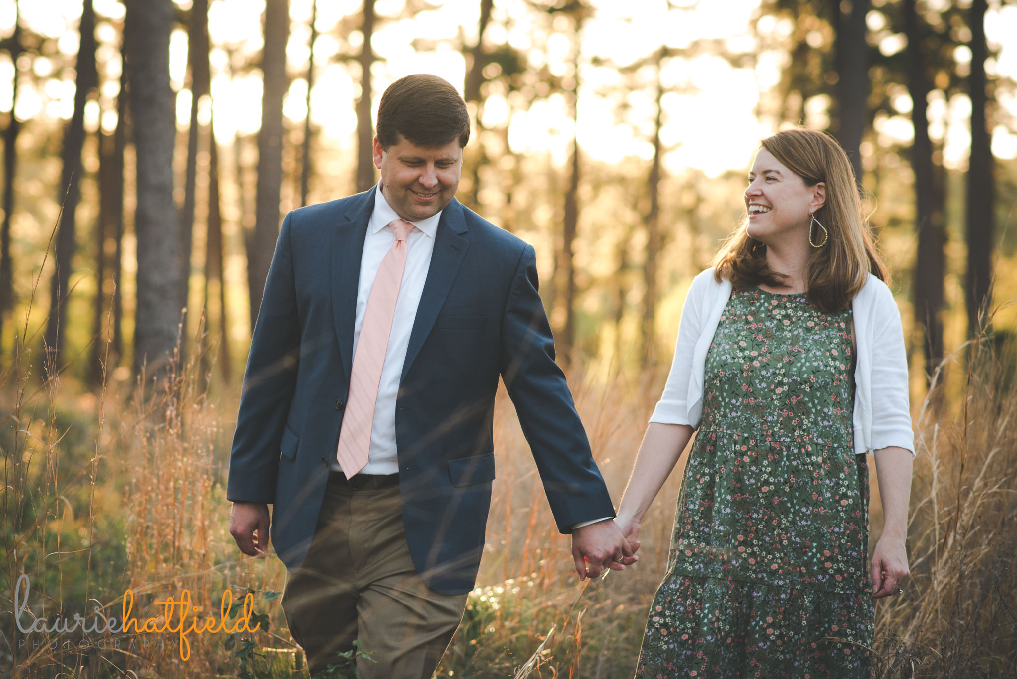 couple holding hands in field | Mobile AL engagement photographer