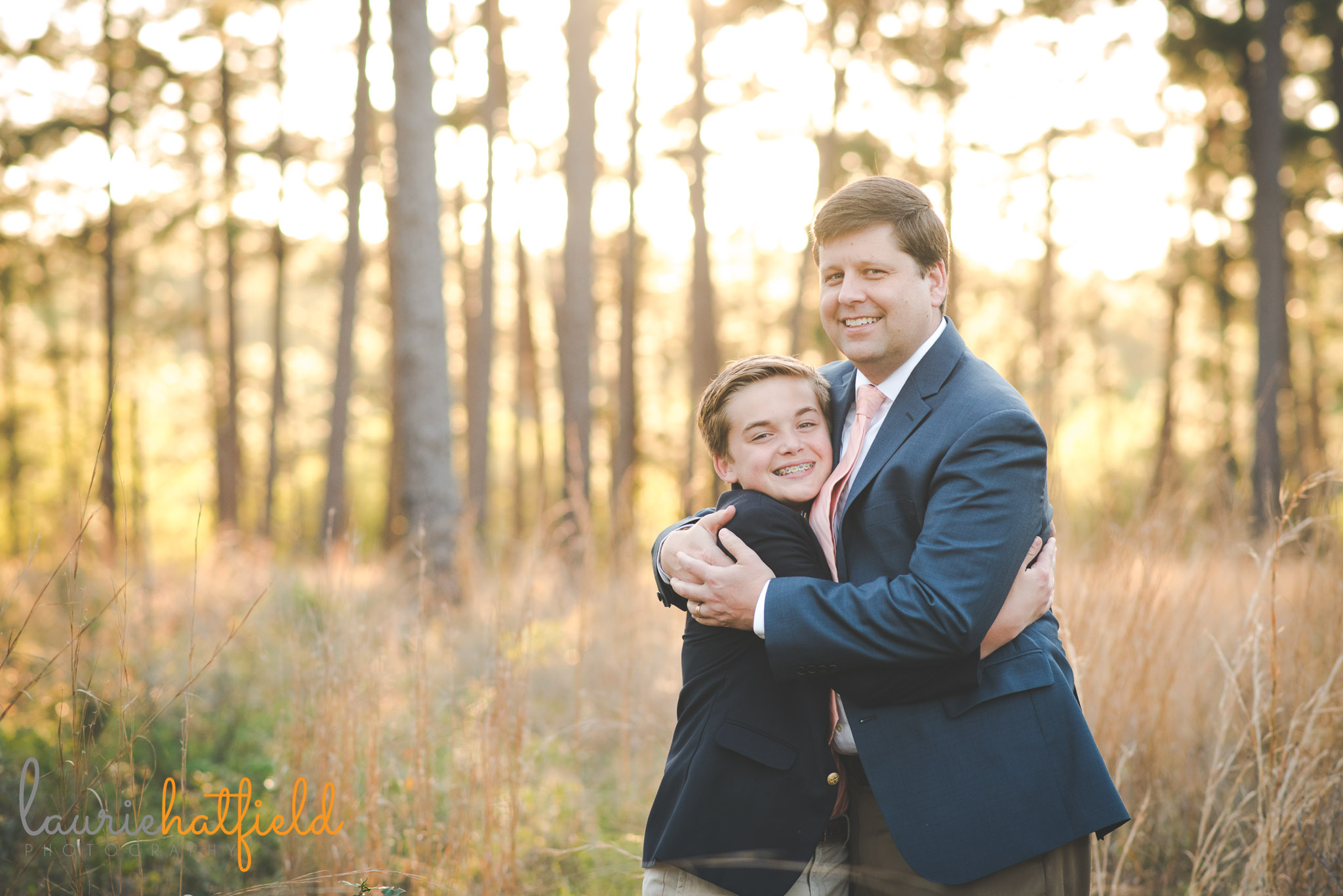 dad hugging son in field | Saraland AL family photographer