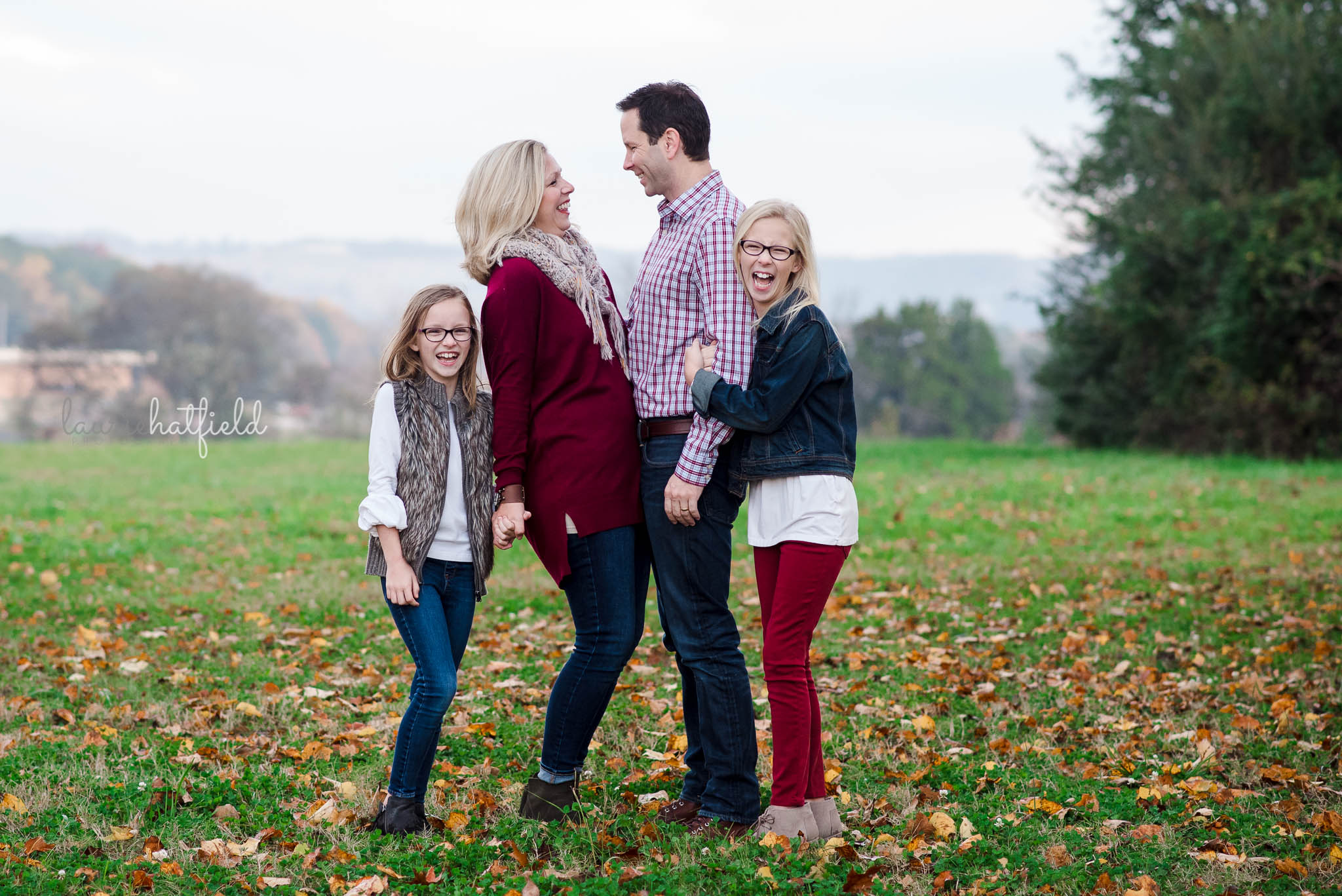 mom, dad, and two daughters in field | Daphne Al family photographer