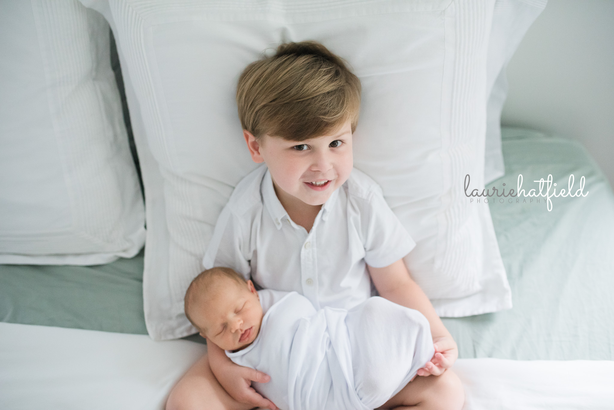 brother holding new baby sister | Mobile AL newborn pictures