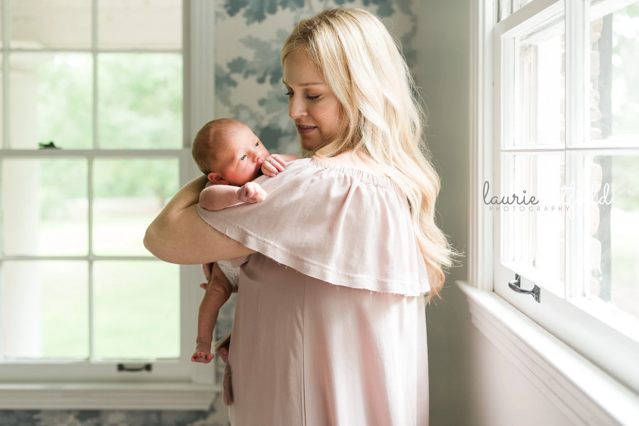 mom holding new baby girl | Mobile AL newborn photographer