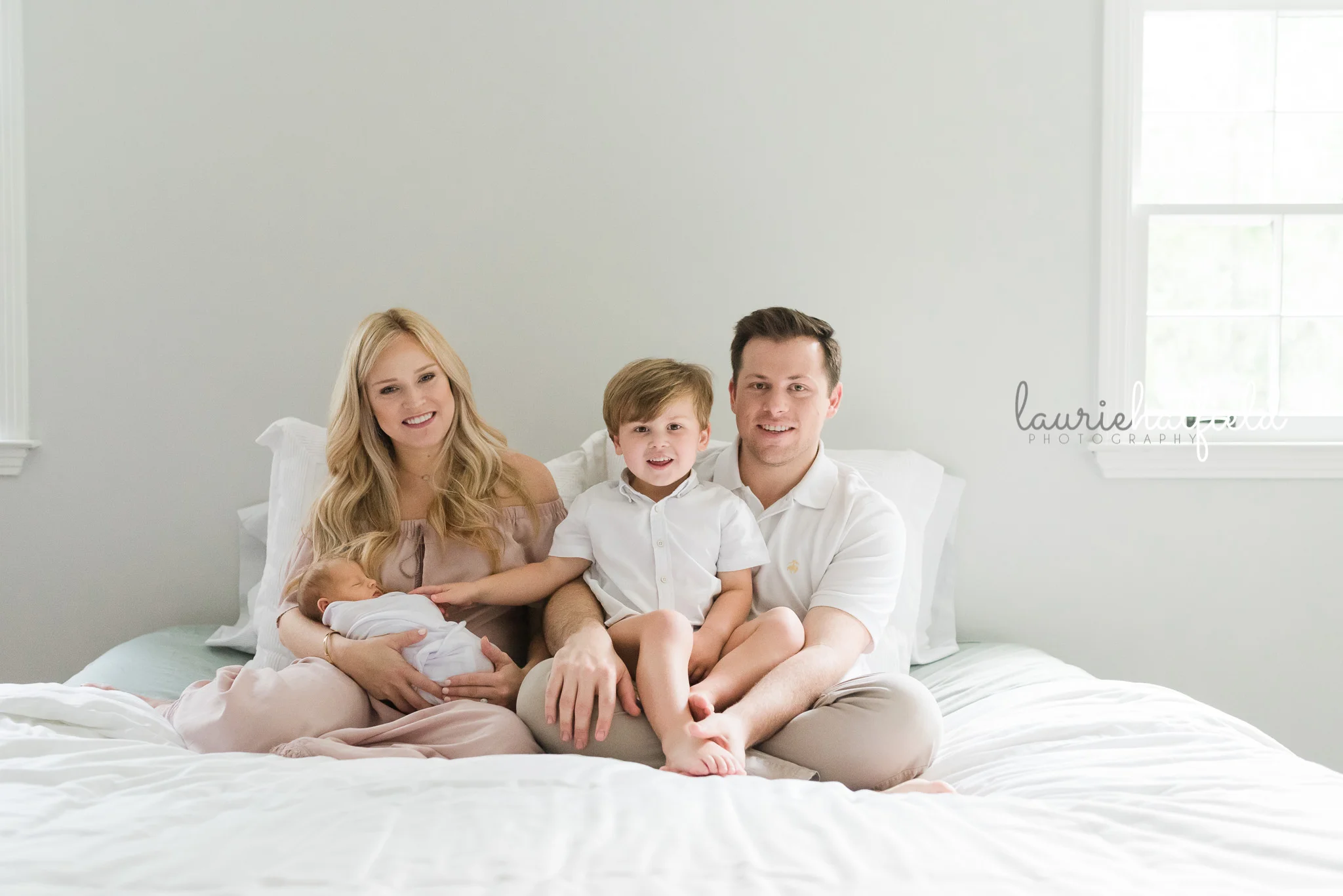 family of four on bed | Mobile AL newborn photographer