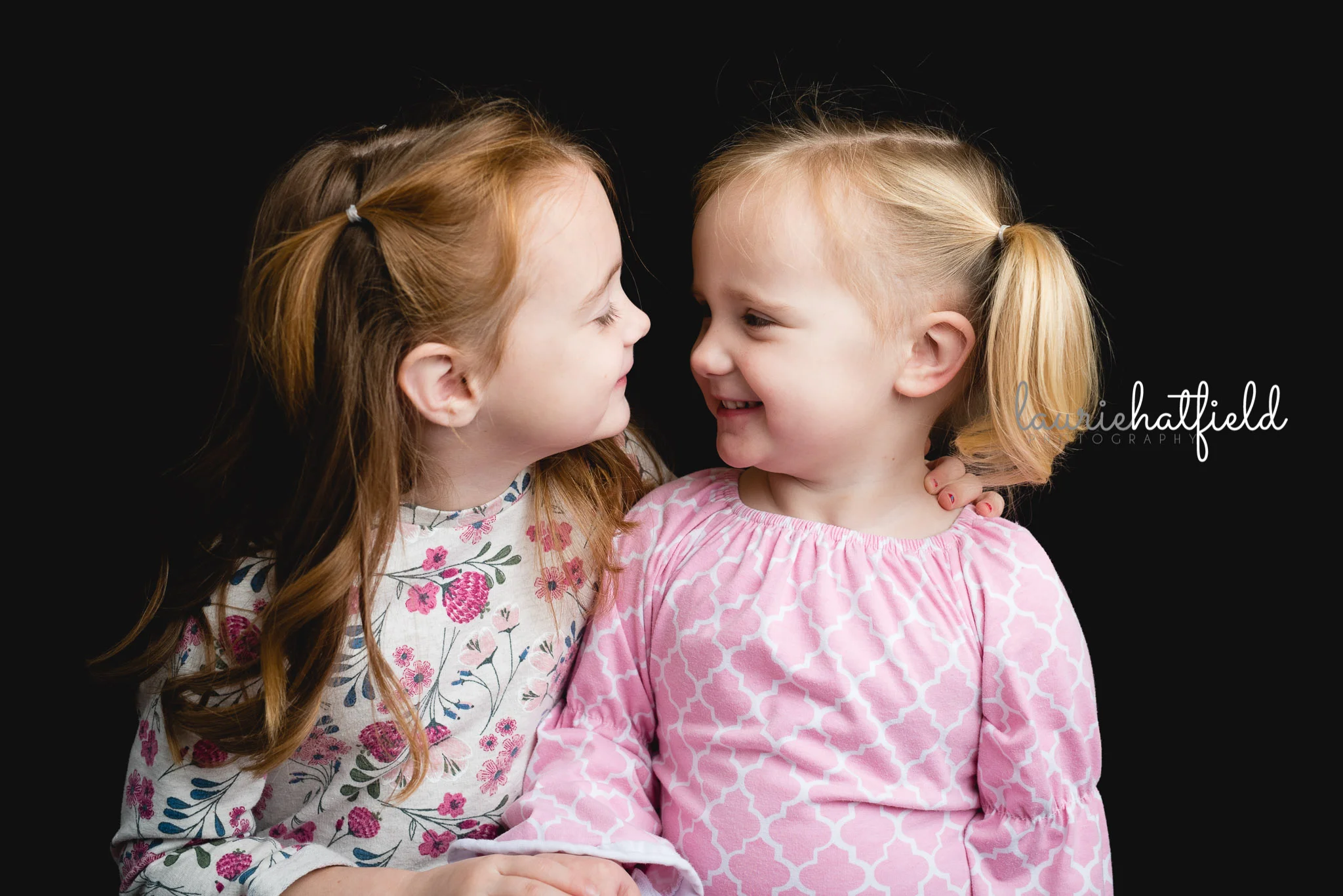 sisters looking at each other | Huntsville AL preschool portraits