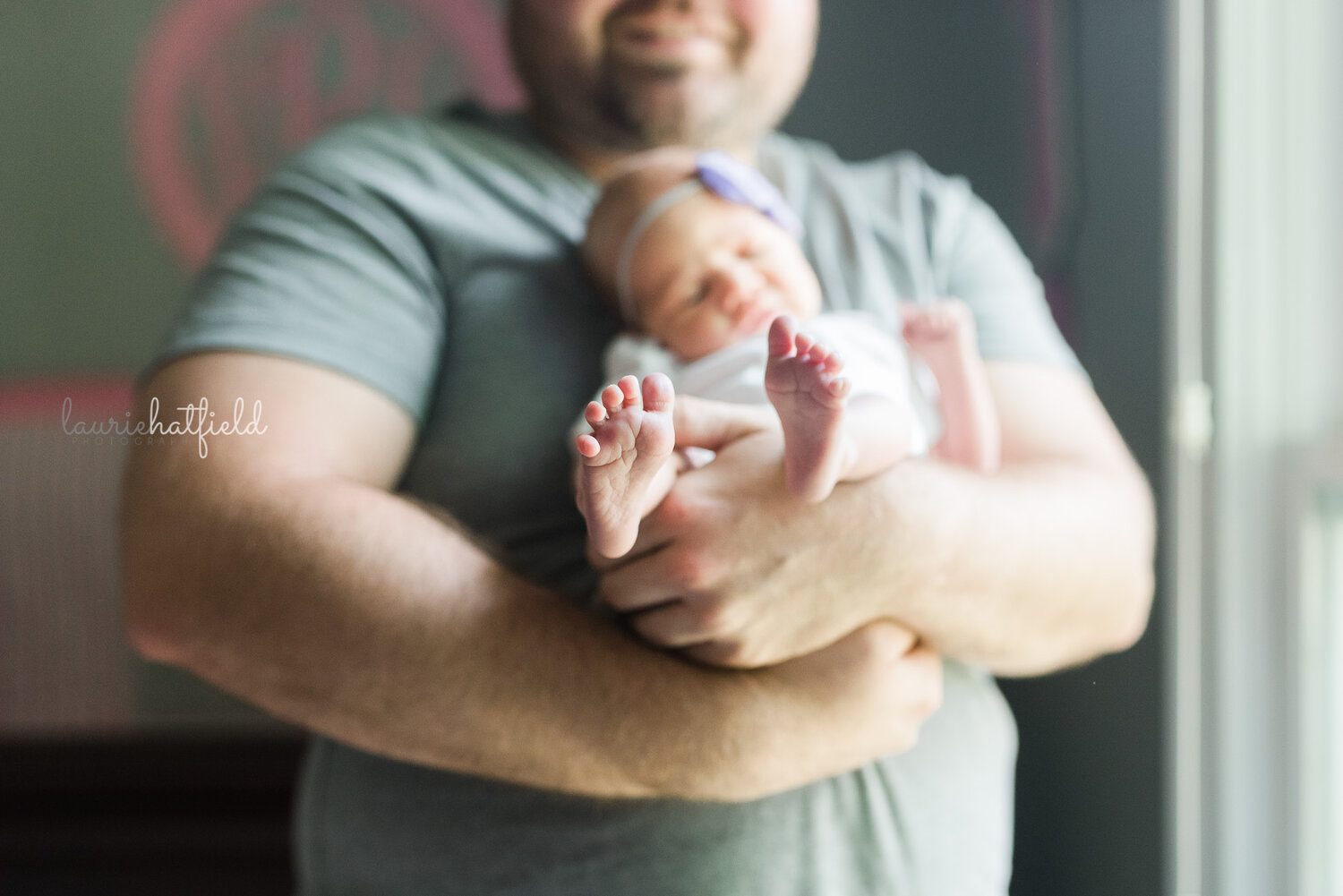 dad holding baby girl feet | Decatur AL newborn photographer