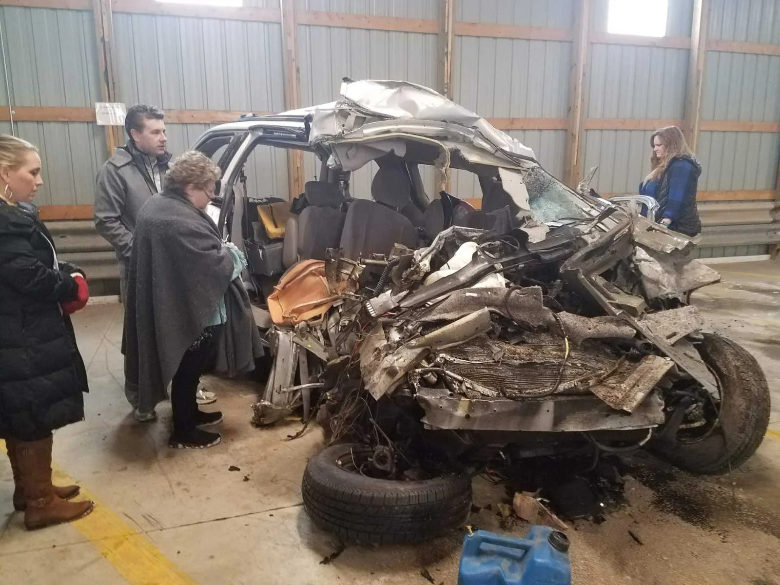The van my sister took her last breath in, after someone crossed the center line and hit her head on. My mom, brother, and sister-in-law take their first look at the vehicle after the accident.