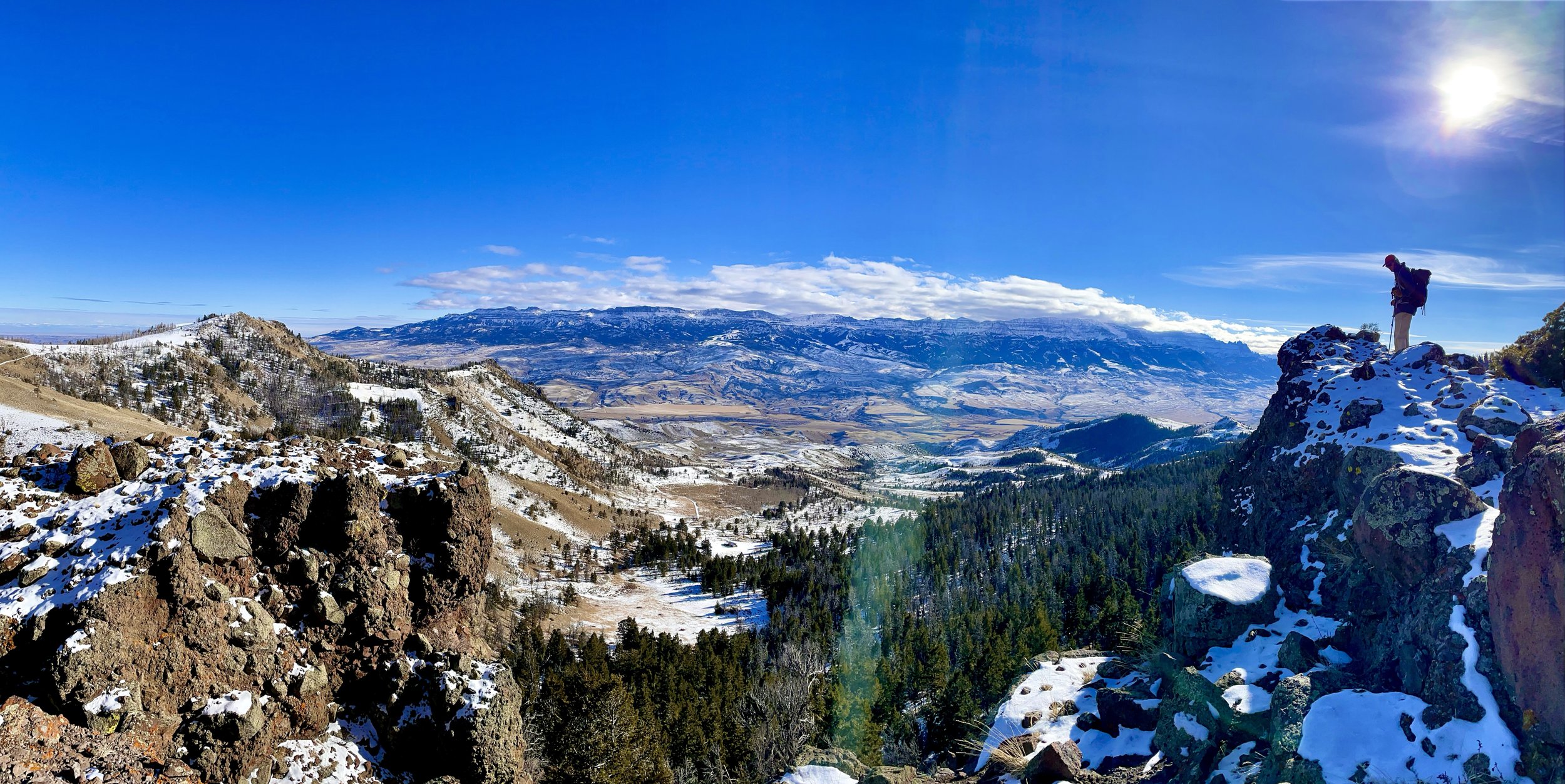 Winter 2021 - View of Will looking down the South Fork Valley of the Shoshone River from one of our wolf GPS clusters on a collaborating ranch. 
