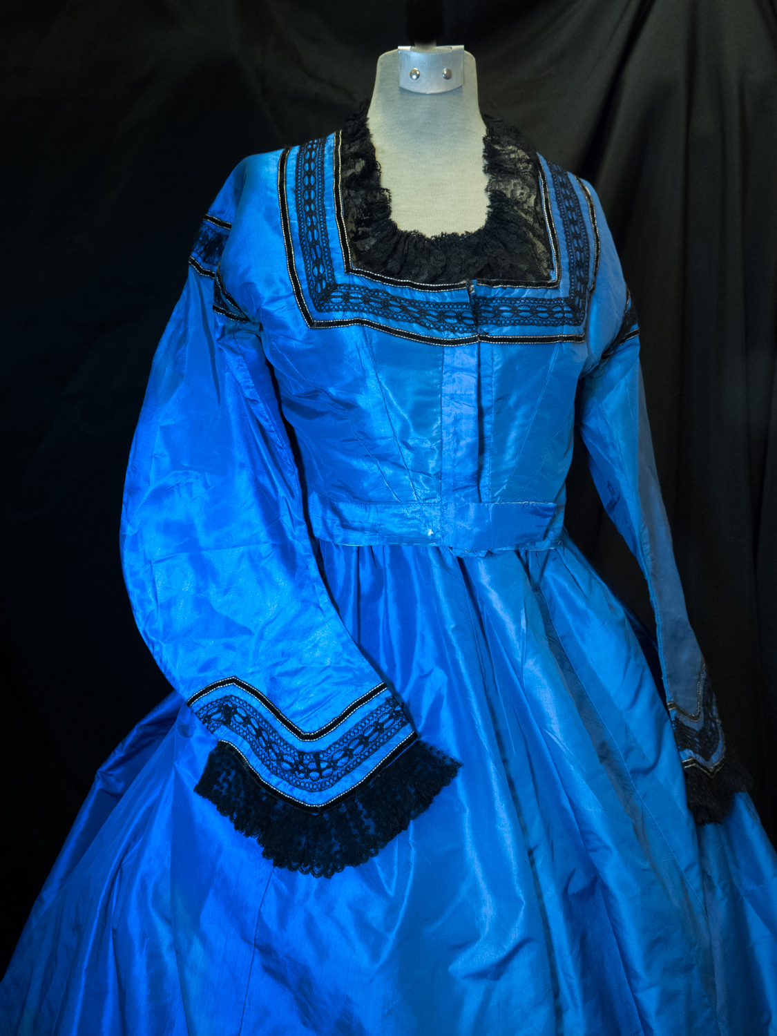  Dinner dress circa 1863. Silk taffeta aniline. Blue trimmed with black laces and black velvet ribbon skirt.&nbsp; 