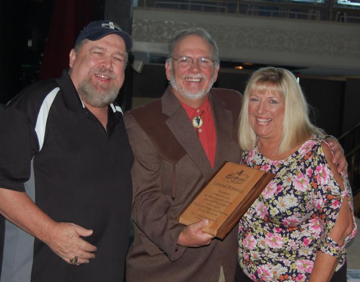 Linda Powell, pictured on the right, receives her Hall of Fame plaque from Garry Mason, center, and Ray Eye, left.