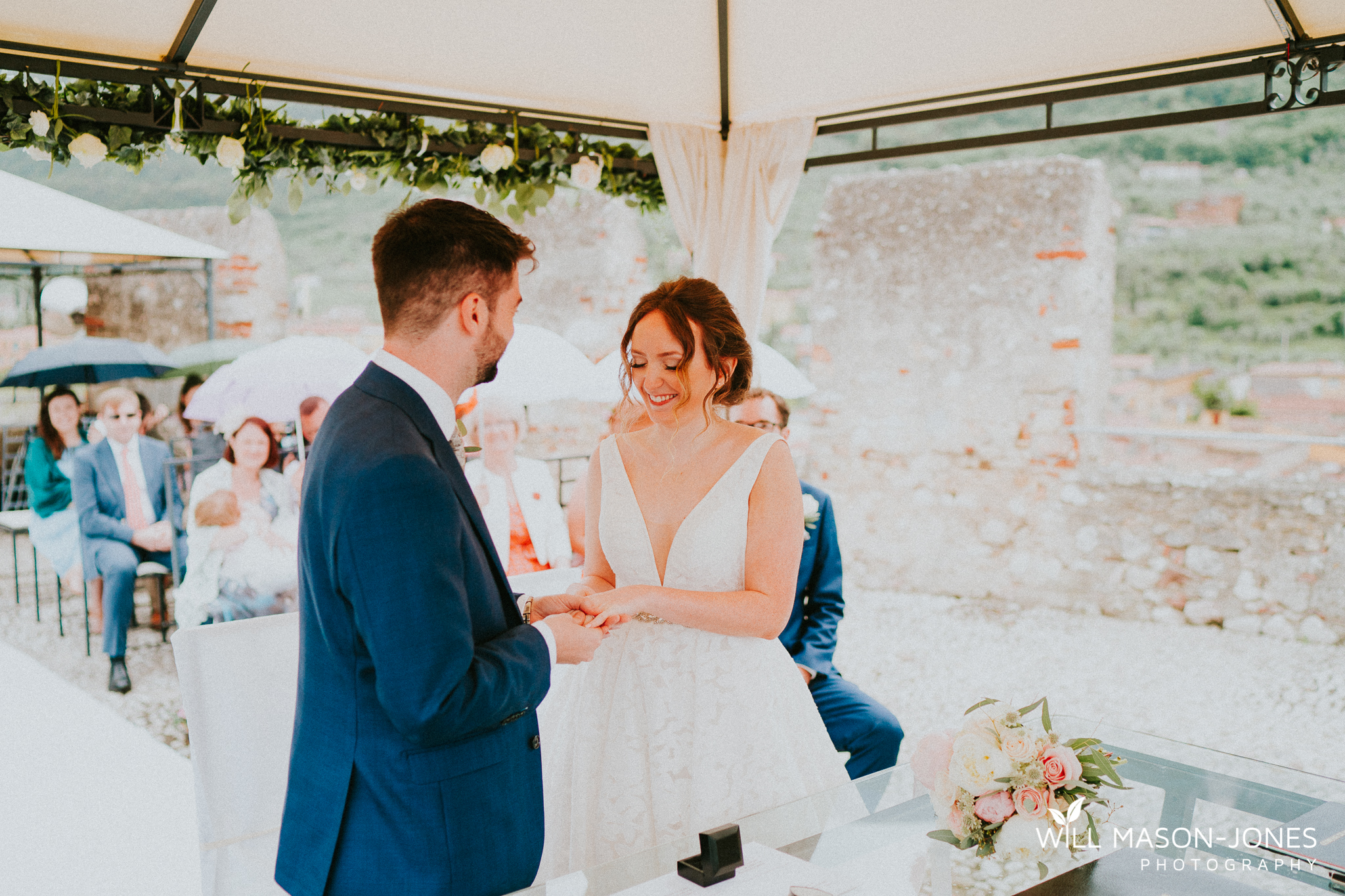  colourful rainy wet outdoor destination wedding ceremony at malcesine castle photography 