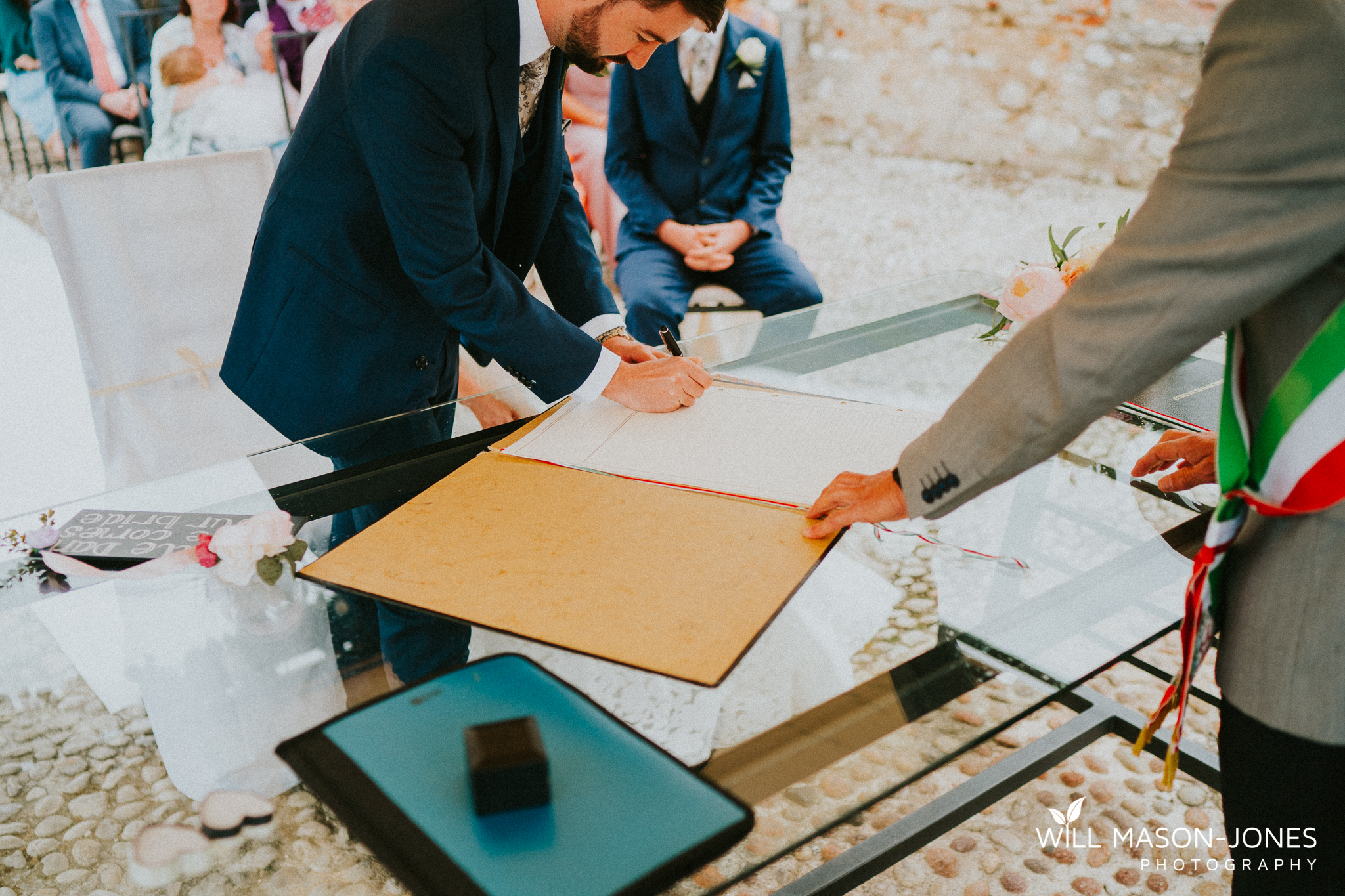  colourful rainy wet outdoor destination wedding ceremony at malcesine castle photography 