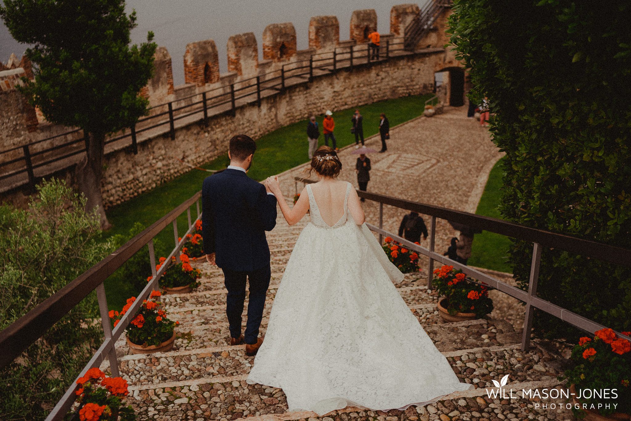  colourful rainy wet outdoor destination wedding ceremony at malcesine castle photography 