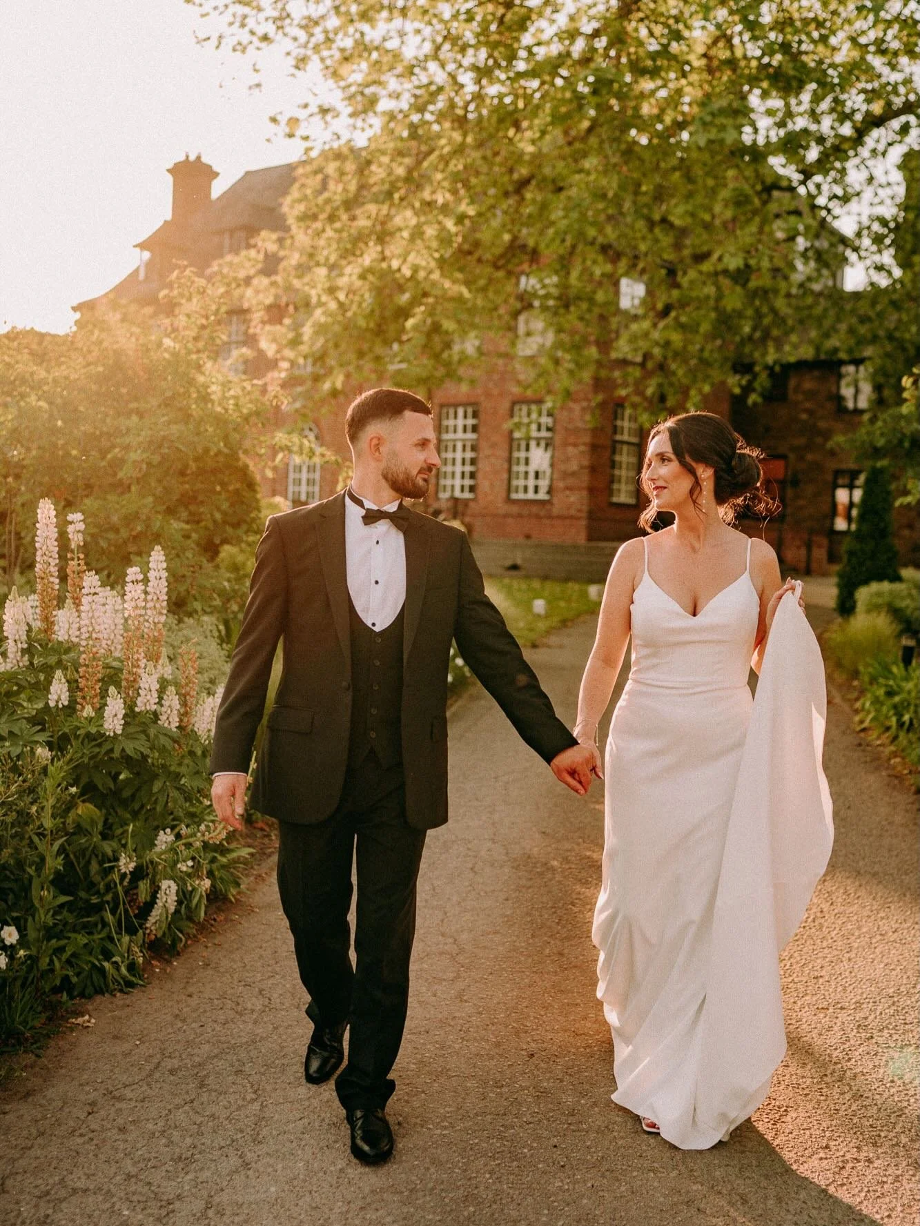 Hottest wedding I&rsquo;ve ever photographed in the UK but look how effortlessly cool Conor &amp; Aimee looked 🕺🏻 🔥 @santffraedhouse looking magical during golden hour, Lupins glowing in the sun 🌞 The dreamiest day in the scorching sunshine! Abso