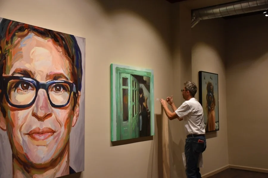 DAVID HUMMER, EXECUTIVE DIRECTOR OF WMOCA, PUTS THE FINISHING TOUCHES ON A NEW EXHIBITION SLATED TO OPEN THIS WEEK IN WAUSAU. (CREDIT: SHEREEN SIEWERT/WAUSAU PILOT & REVIEW)