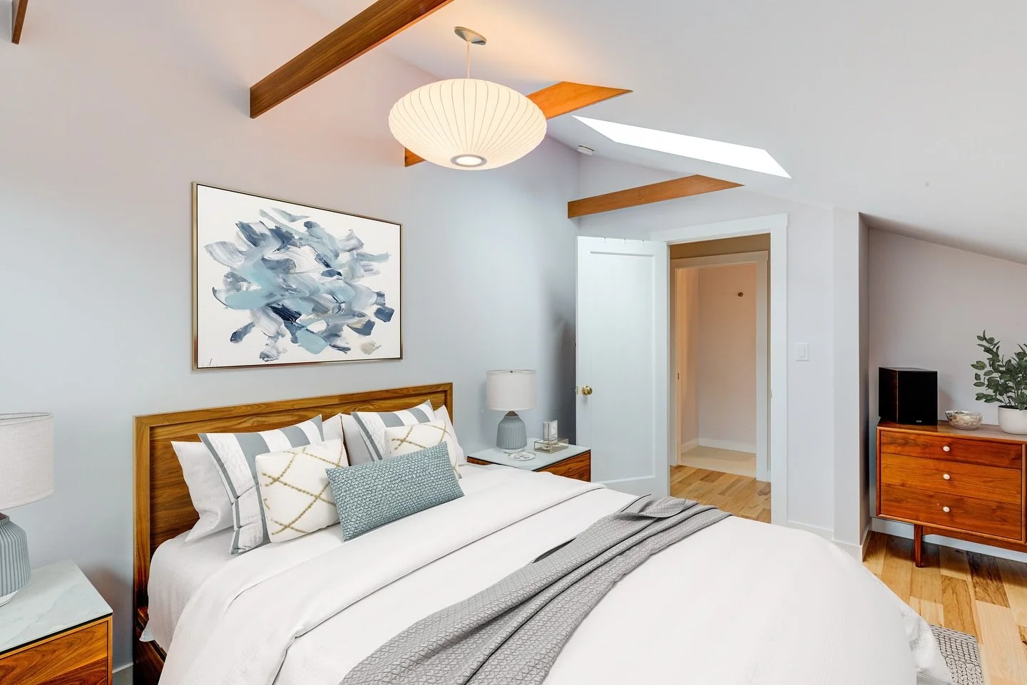 One space within a thoughtfully reimagined attic. This bedroom is filled with natural light from skylights and finished with exposed cherry wood beams for warmth and character.

Designed to feel calm, elevated, and effortlessly comfortable.