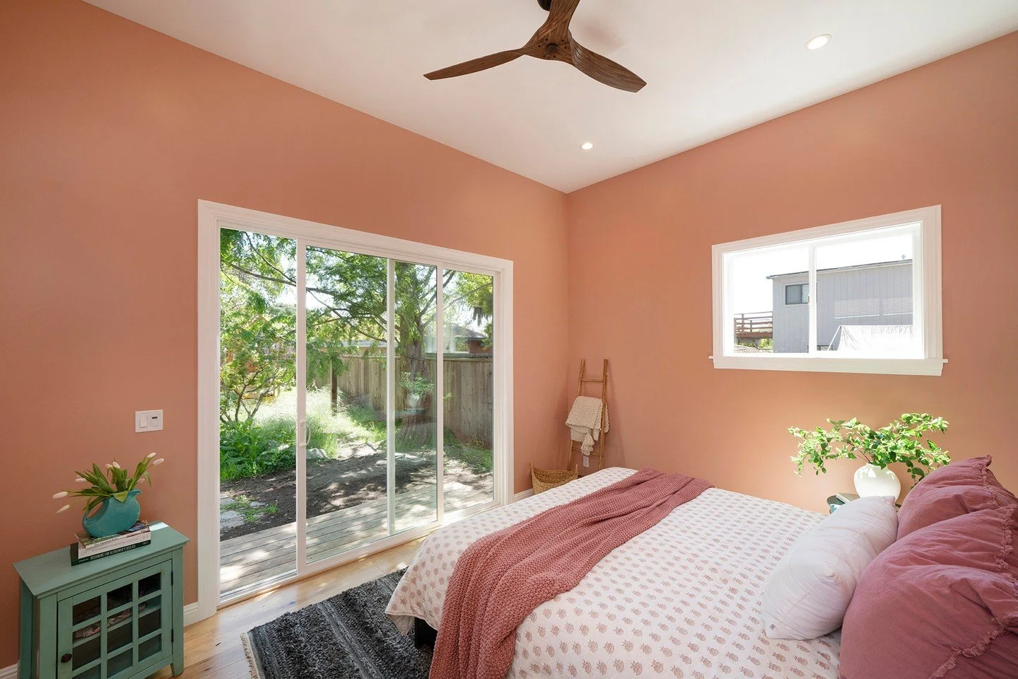 A bedroom designed to feel calm, personal, and quietly inviting. Soft blush tones, natural light, and thoughtful details create a space meant for slowing down.