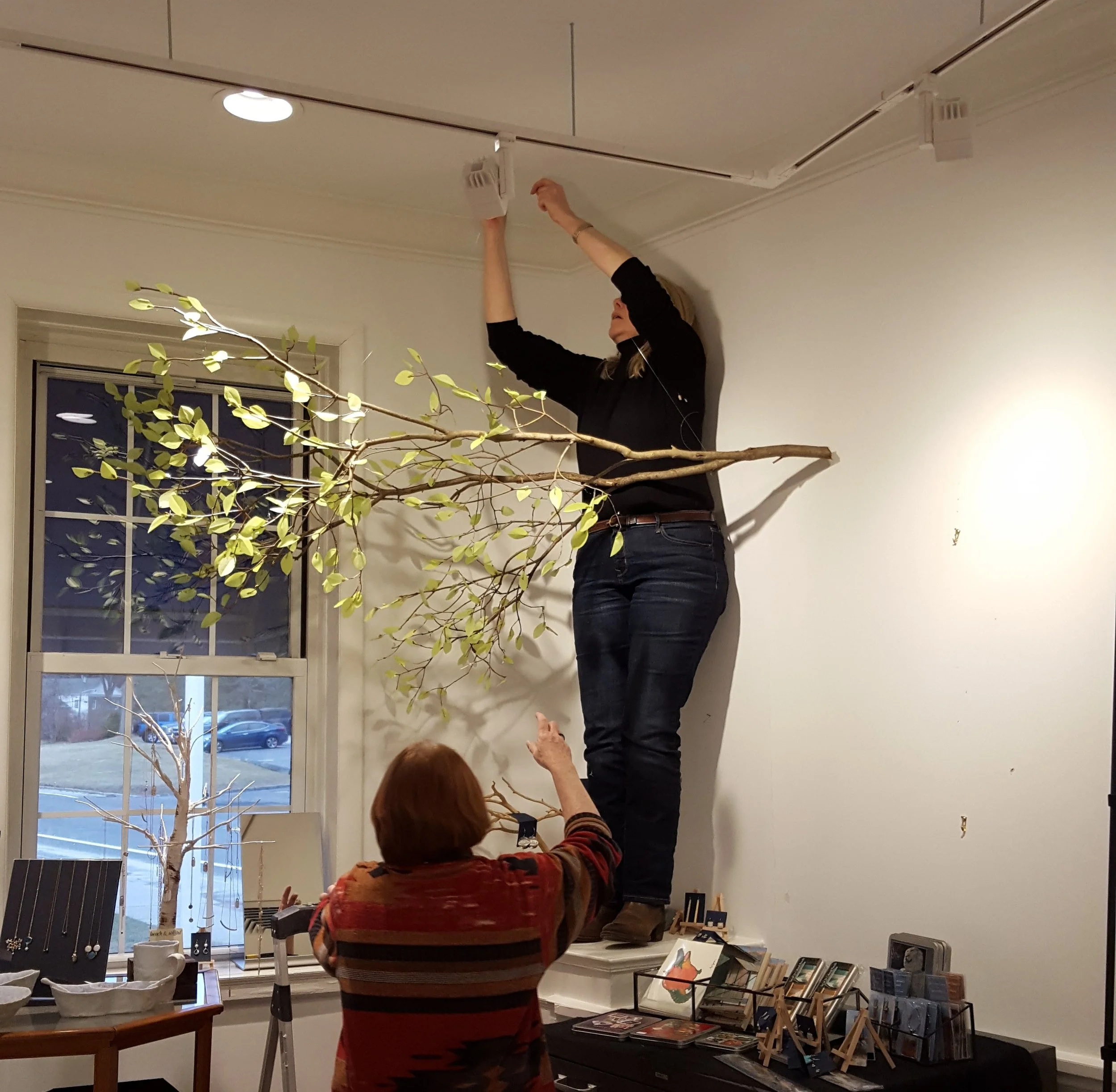 Lois Reboli, Pam Brown, and Cathy Haenlein working on changing the exhibit.