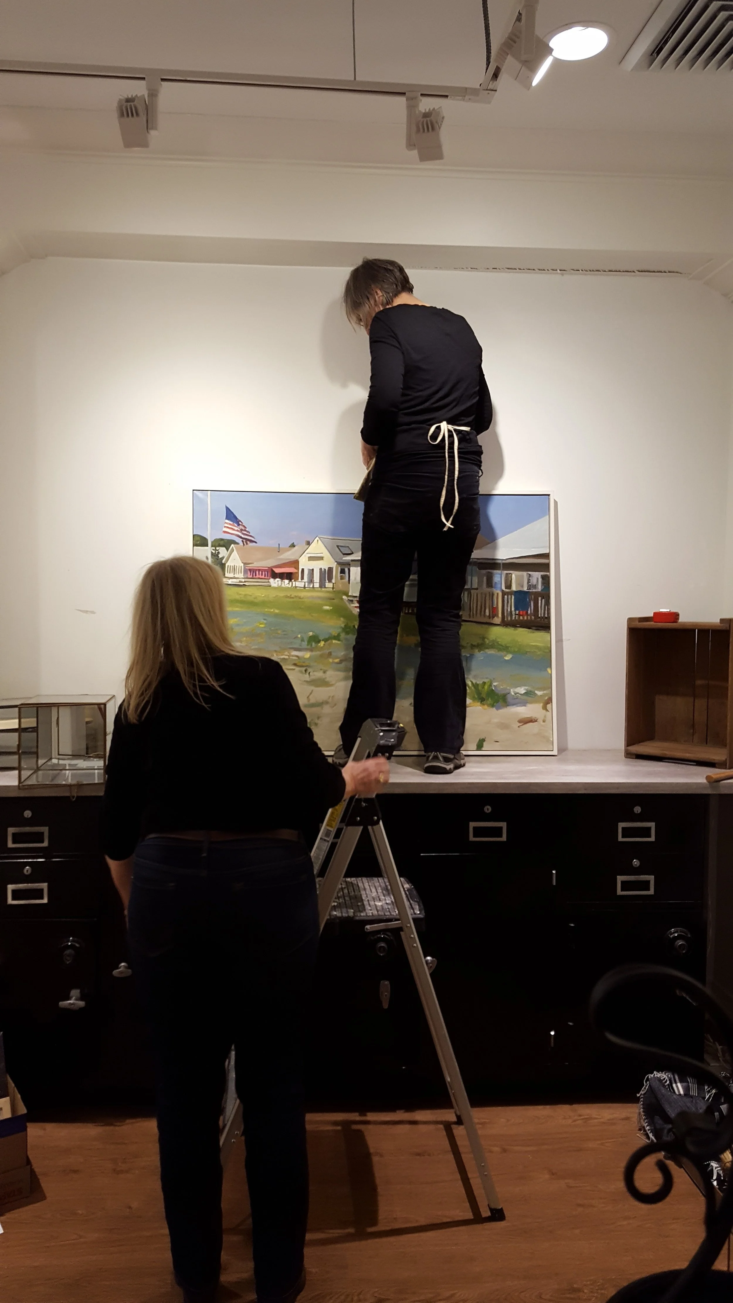 Lois Reboli, Pam Brown, and Cathy Haenlein working on changing the exhibit.
